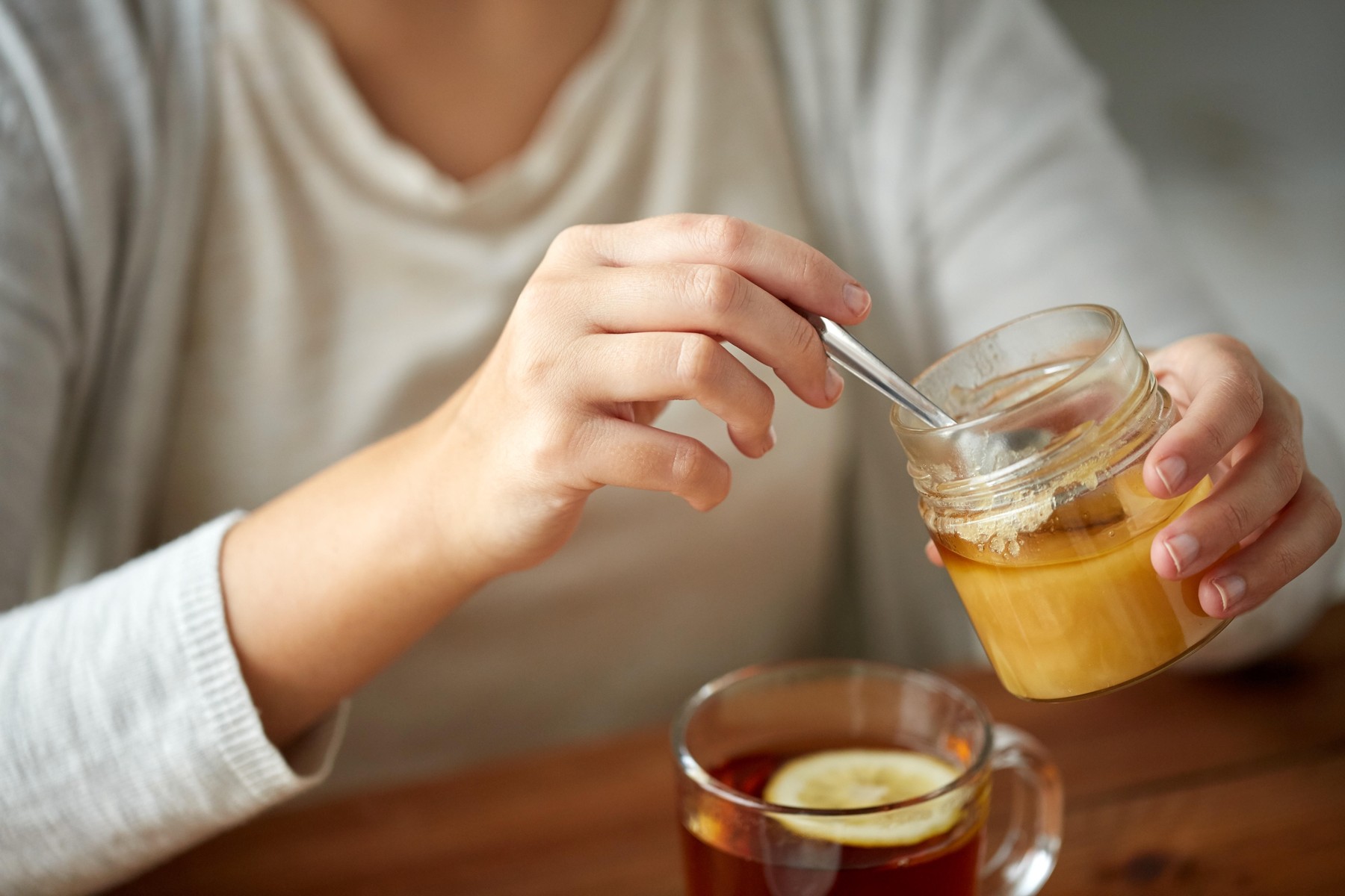 health, traditional medicine and ethnoscience concept - close up of woman adding honey to tea with lemon,Image: 307405433, License: Royalty-free, Restrictions: , Model Release: yes, Credit line: Lev Dolgachov / Alamy / Alamy / Profimedia