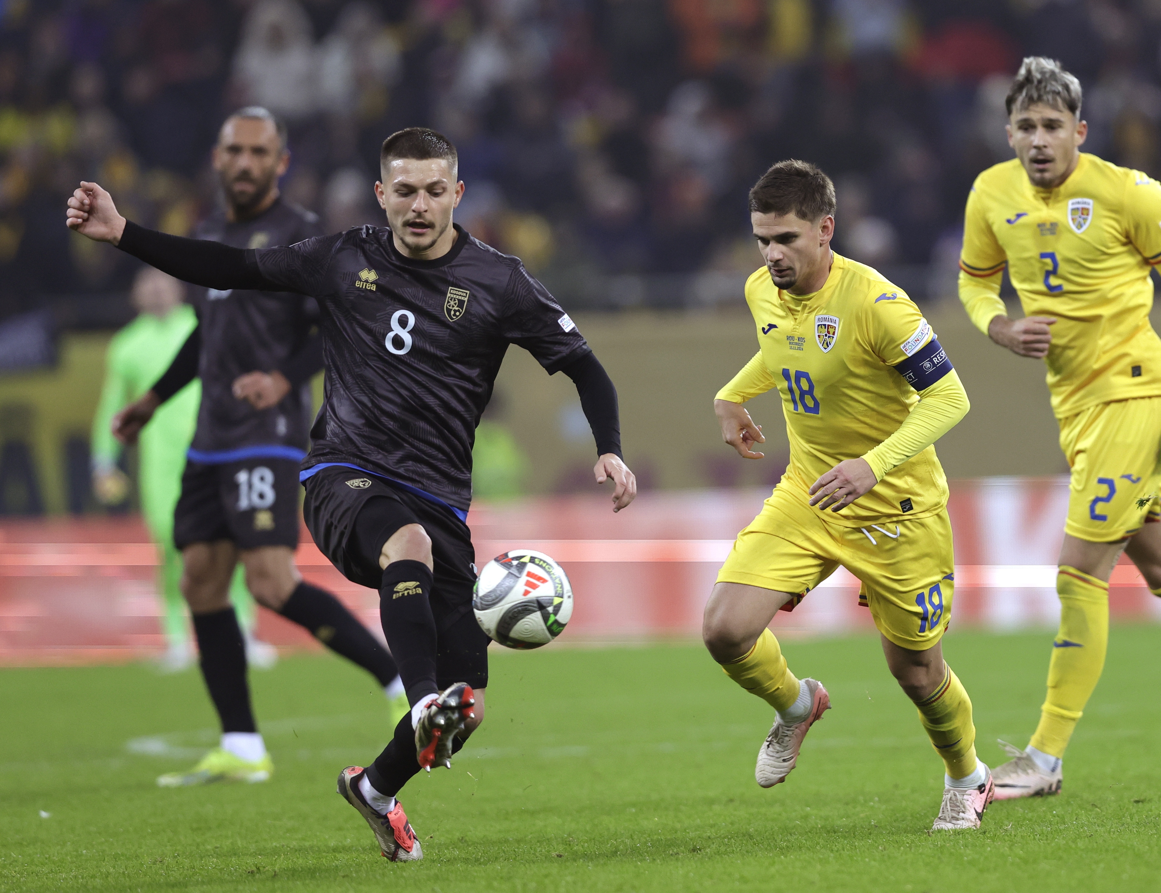 epa11723450 Kosovo's Florent Muslija (L) and Romania's Razvan Marin (R) in action during the UEFA Nations League soccer match between Romania and Kosovo, in Bucharest, Romania, 15 November 2024.  EPA-EFE/ROBERT GHEMENT