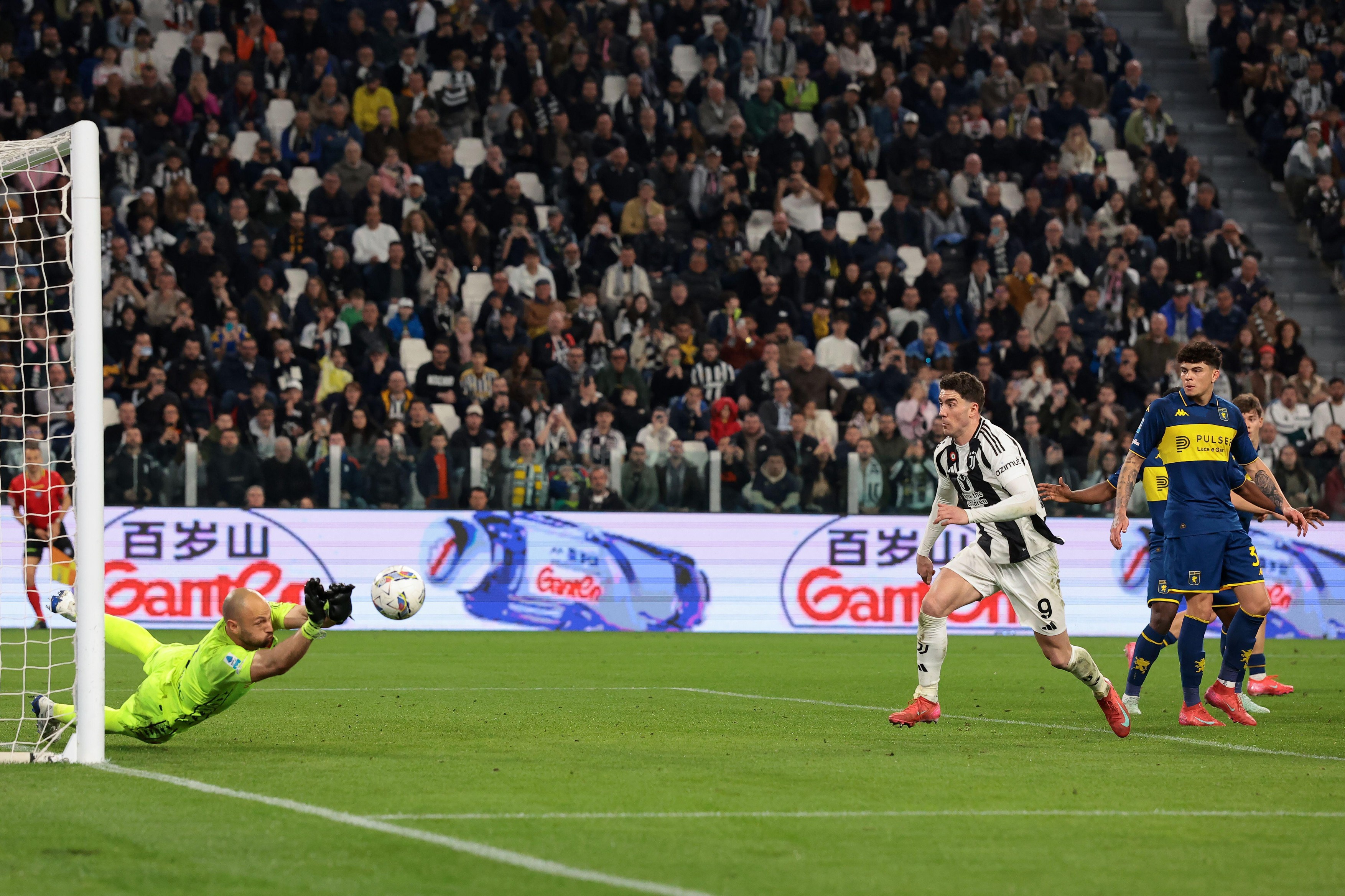 Turin, Italy, 29th March 2025. Dusan Vlahovic of Juventus closes in as Nicola Leali of Genoa CFC palms away a header from Pierre Kalulu of Juventus during the Serie A match at Allianz Stadium, Turin. Picture credit should read: Jonathan Moscrop / Sportima