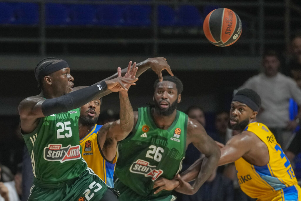 Panathinaikos' Kendrick Nunn, left, tries to score as Maccabi's Lorenzo Brown, second left, blocks him during the Euroleague basketball match between Maccabi Tel Aviv and Panathinaikos in Belgrade, Serbia, Thursday, May 2, 2024. (AP Photo/Darko Vojinovic)
