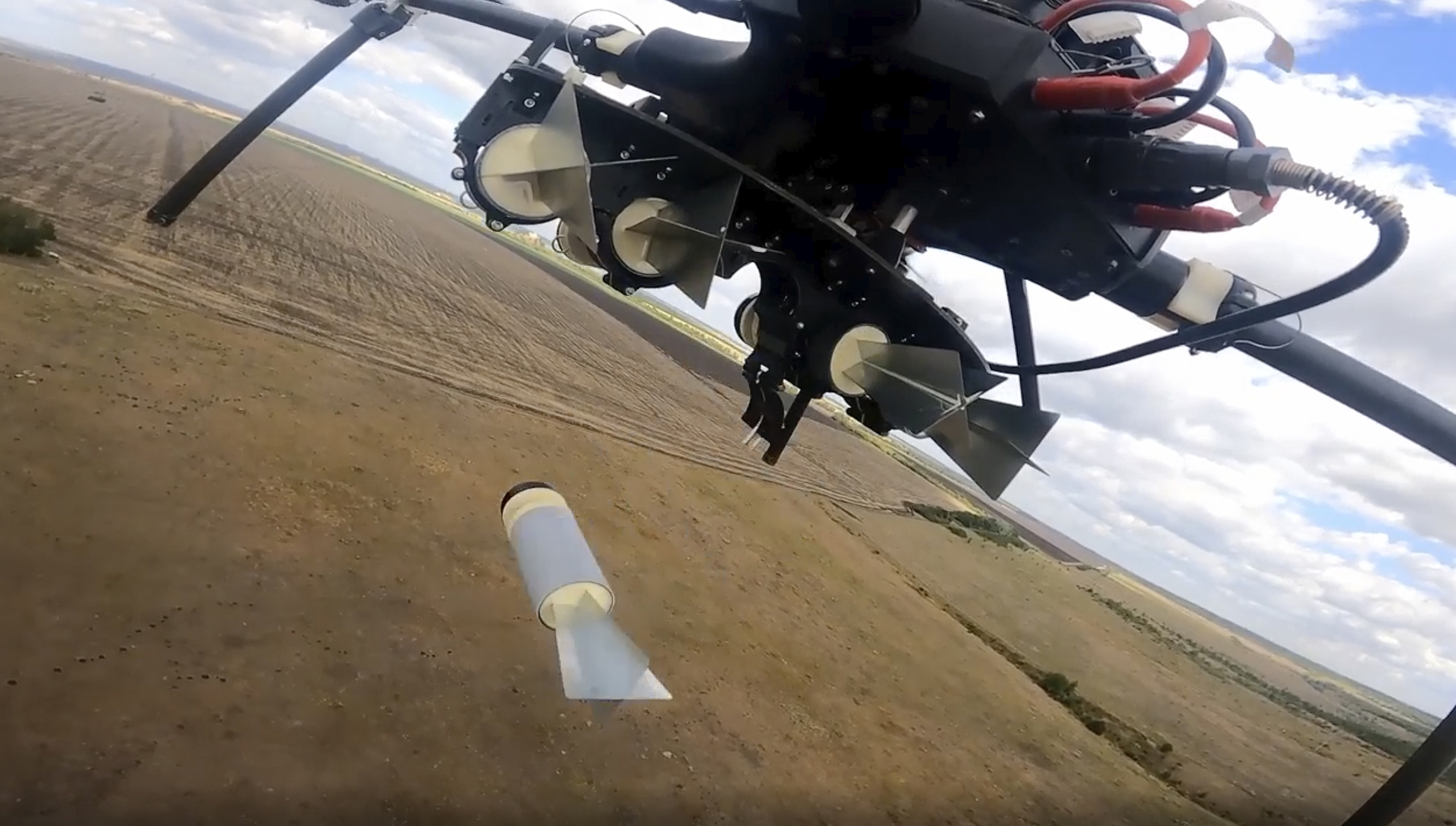 In this photo taken from video released by the Russian Defense Ministry on Tuesday, Sept. 24, 2024, a Russian drone drops an explosive at an undisclosed location in Donetsk region. (Russian Defense Ministry Press Service photo via AP)