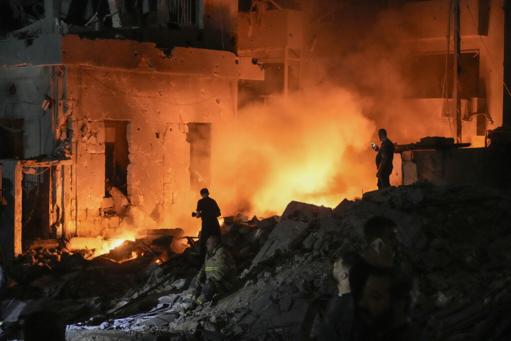 Flames and smoke rise at the scene of destroyed buildings hit by an Israeli airstrike in central Beirut, Lebanon, Thursday, Oct. 10, 2024. (AP Photo/Bilal Hussein)