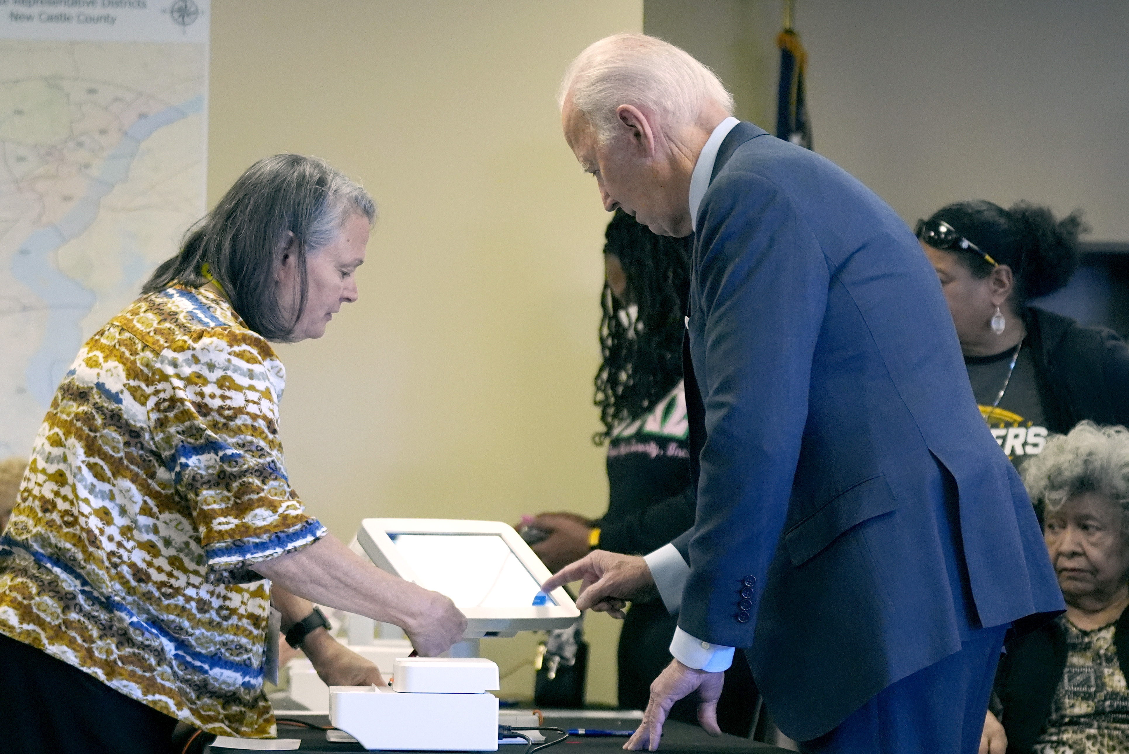 President Joe Biden signs his name at a polling station to cast his early-voting ballot for the 2024 general elections, Monday, Oct. 28, 2024, in New Castle, Del. (AP Photo/Manuel Balce Ceneta)