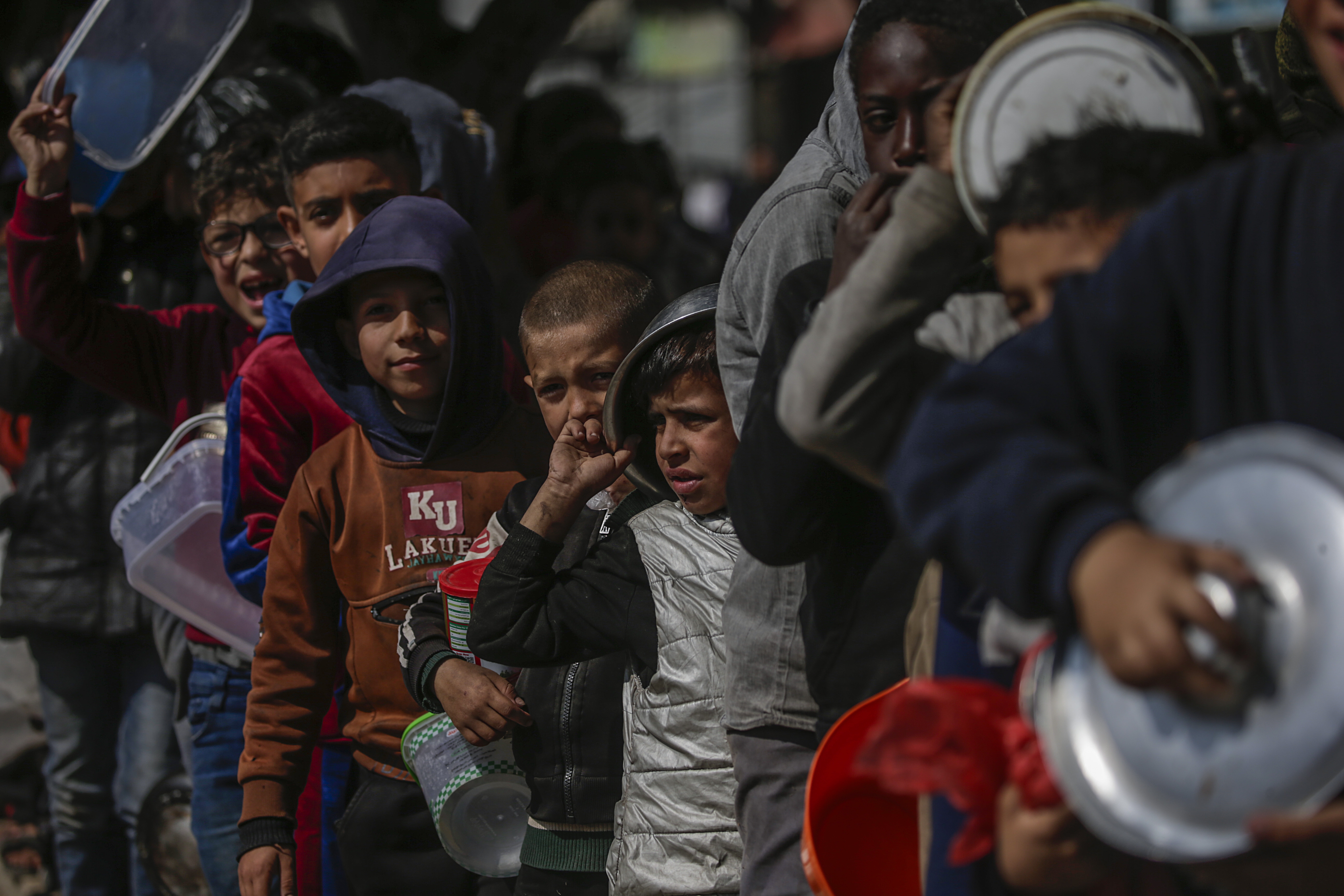 Internally displaced Palestinians receive food aid in Deir Al Balah