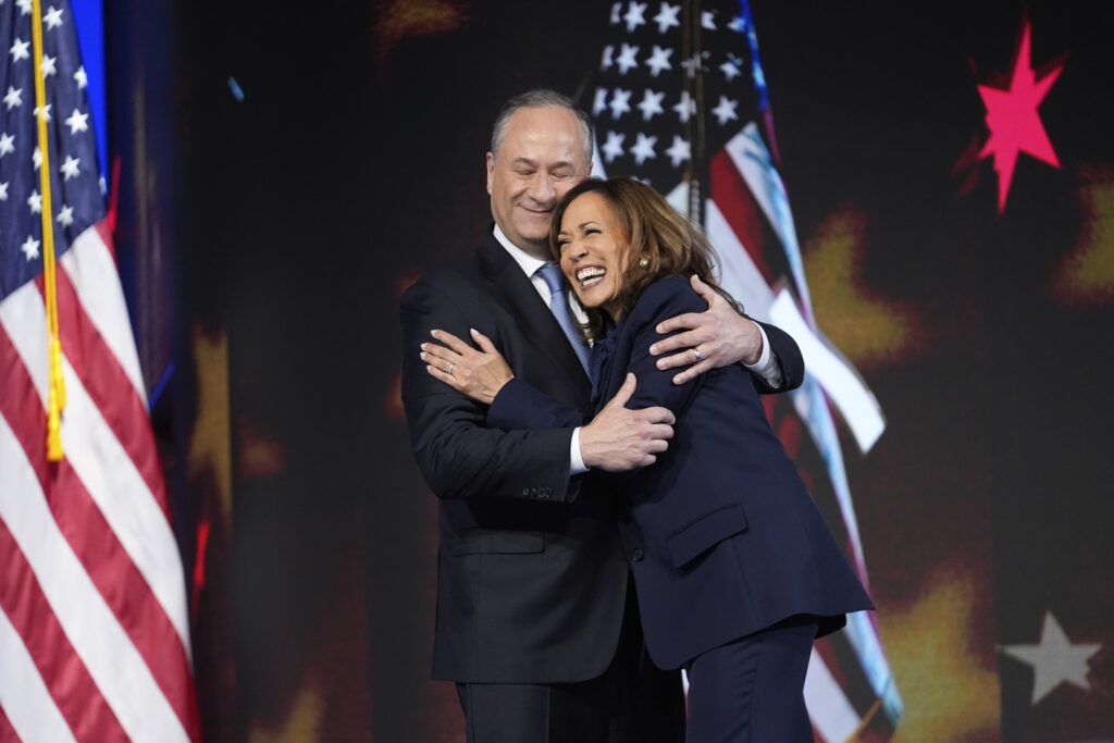 Democratic presidential nominee Vice President Kamala Harris hugs her husband Second gentleman Douglas Emhoff after her nomination speech during the Democratic National Convention Thursday, Aug. 22, 2024, in Chicago. (AP Photo/Paul Sancya)