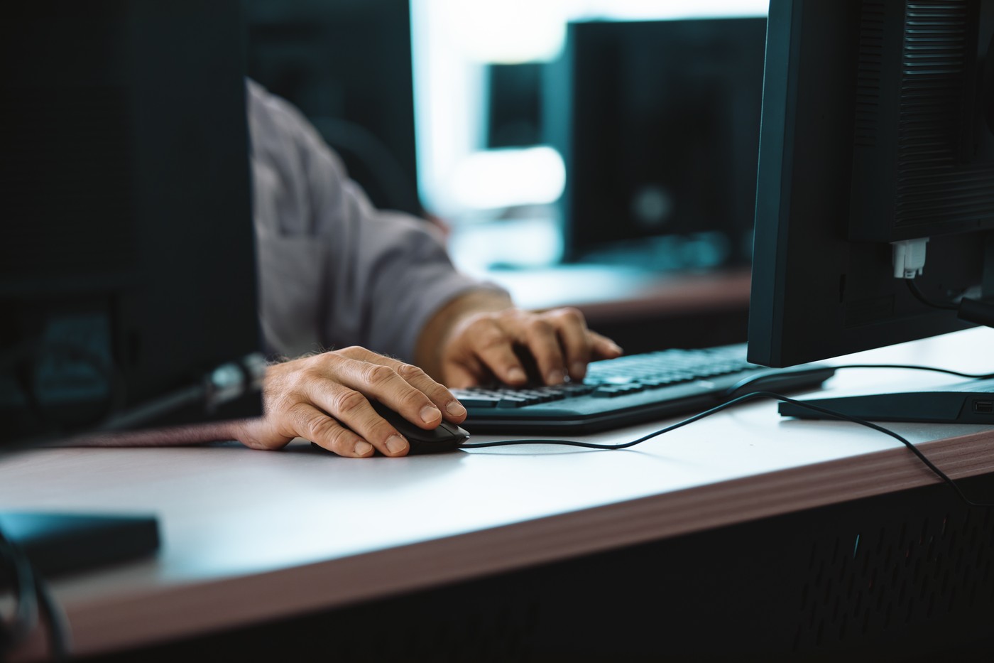 It technician repairing hardware using computer in a training center