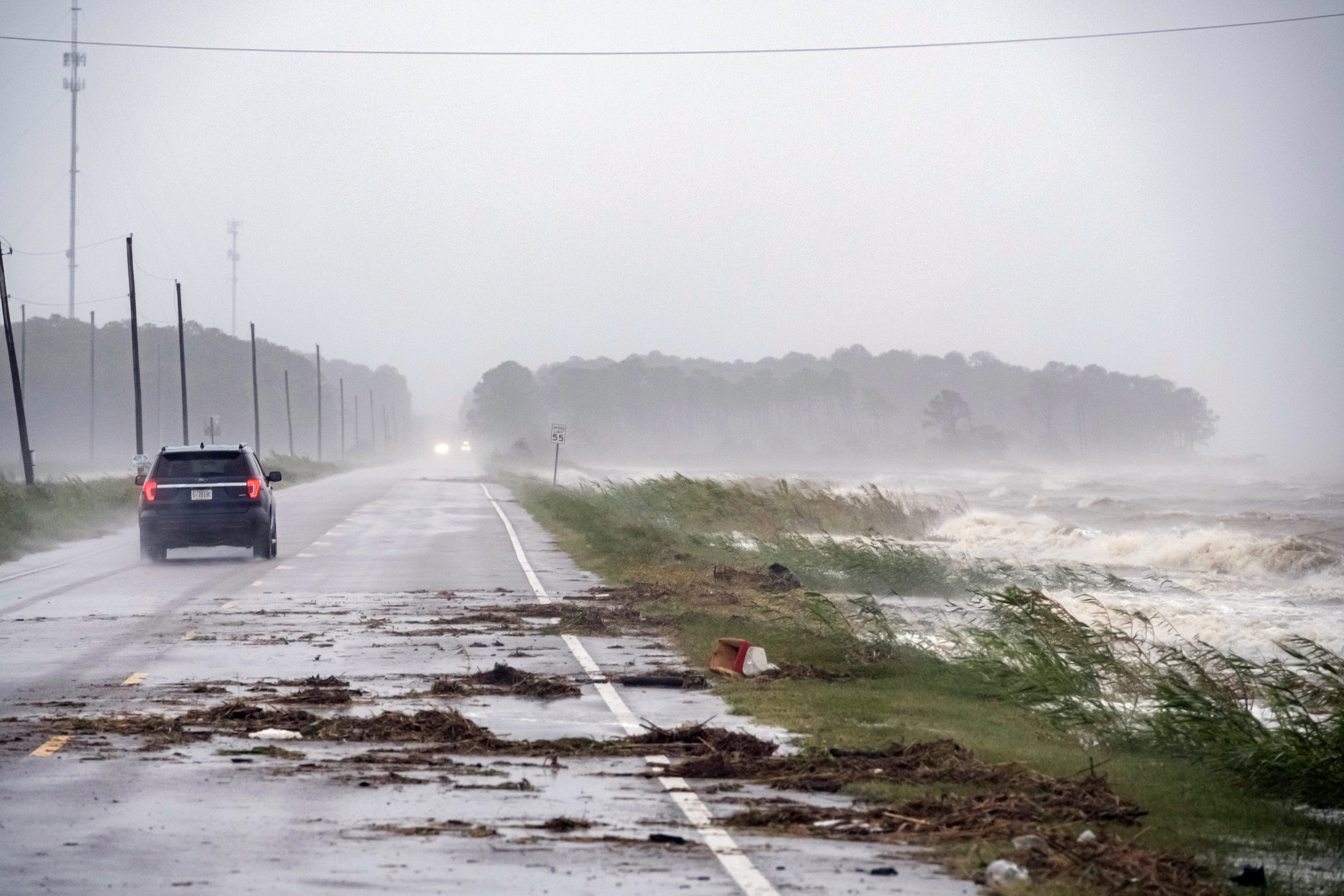 epaselect epa08670437 A car drives by crashing waves as Hurricane Sally approaches in Alabama Port, Alabama, USA, 15 September 2020. Hurricane Sally is predicted to make landfall early 16 September as a Category 1 hurricane.  EPA-EFE/DAN ANDERSON