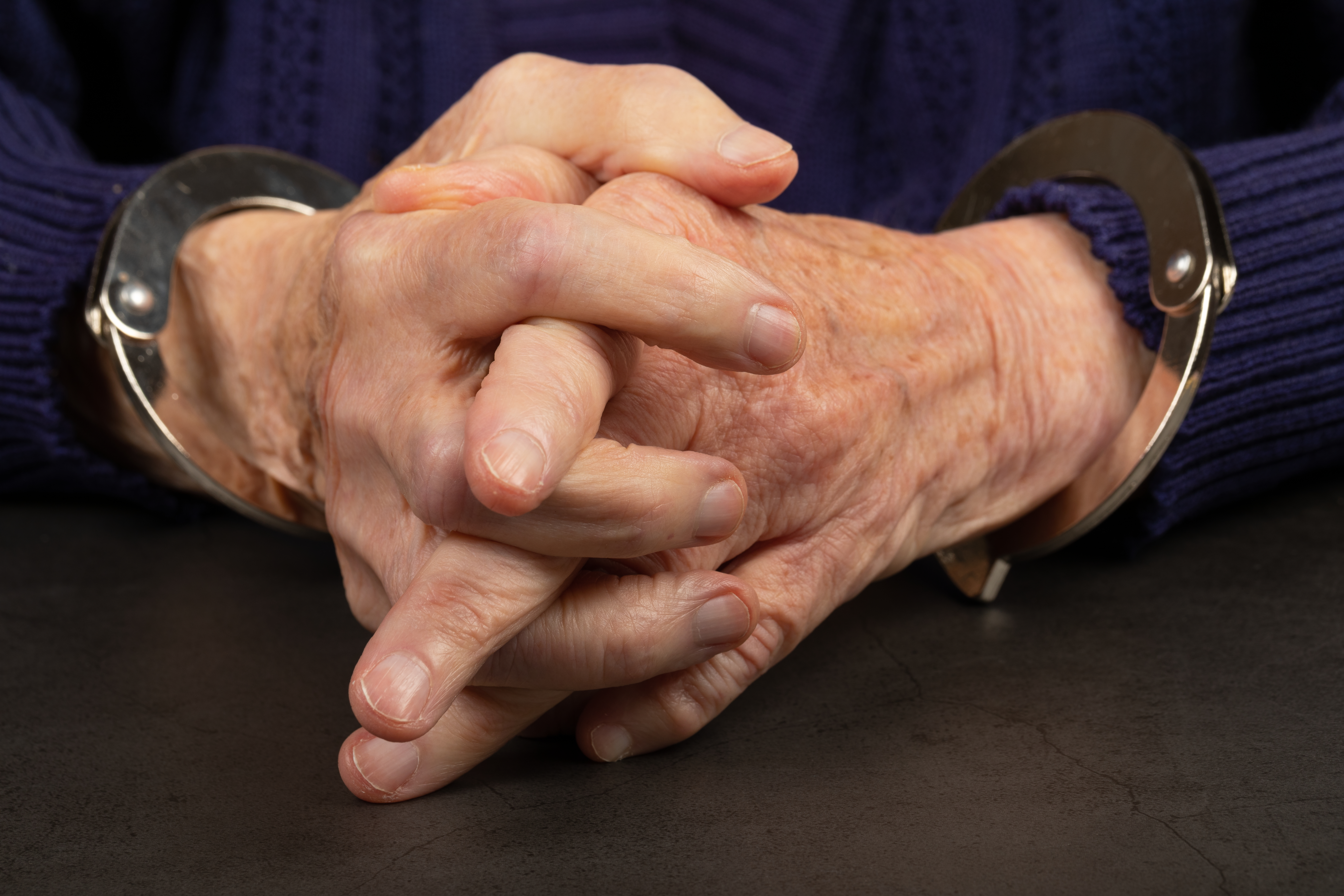 Close,Up,Photo,Of,A,Handcuffed,Elderly,Woman