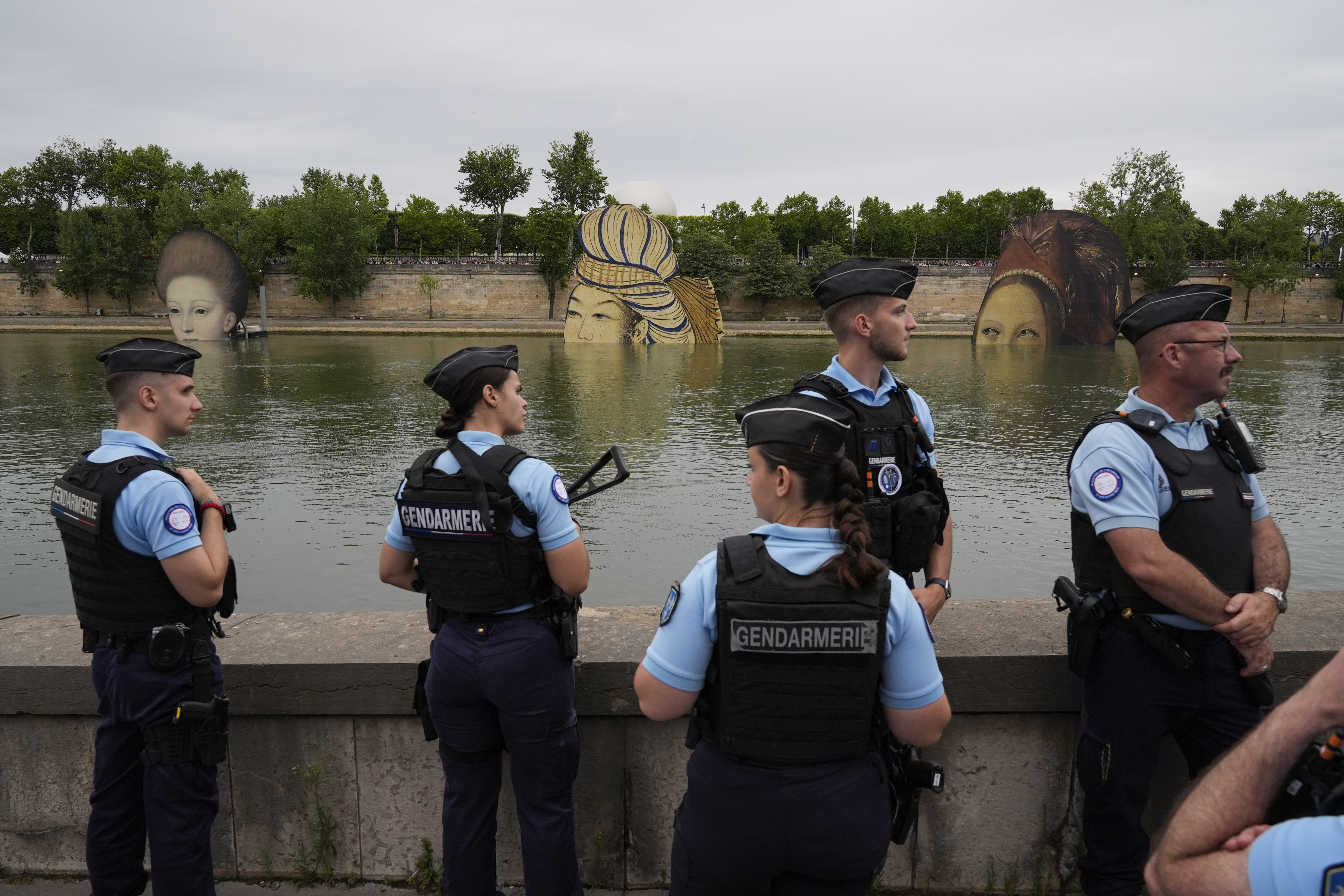 Police officers patrol along the Seine in Paris, France, during the opening ceremony of the 2024 Summer Olympics, Friday, July 26, 2024. (AP Photo/Rebecca Blackwell)