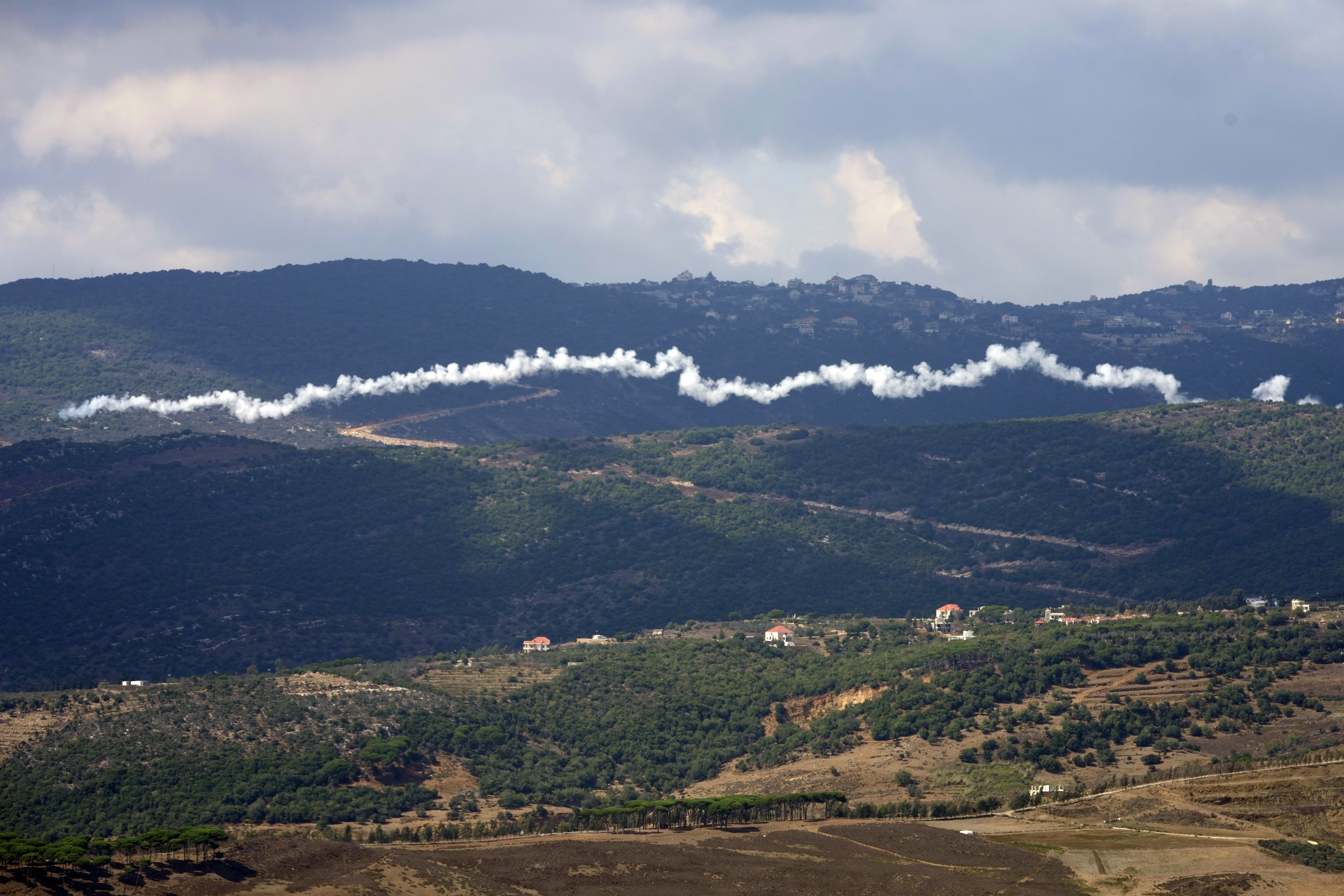The smoke trail from a Hezbollah rocket, seen from the southern Lebanese town of Marjayoun, Saturday, Sept. 21, 2024. (AP Photo/Hussein Malla)
