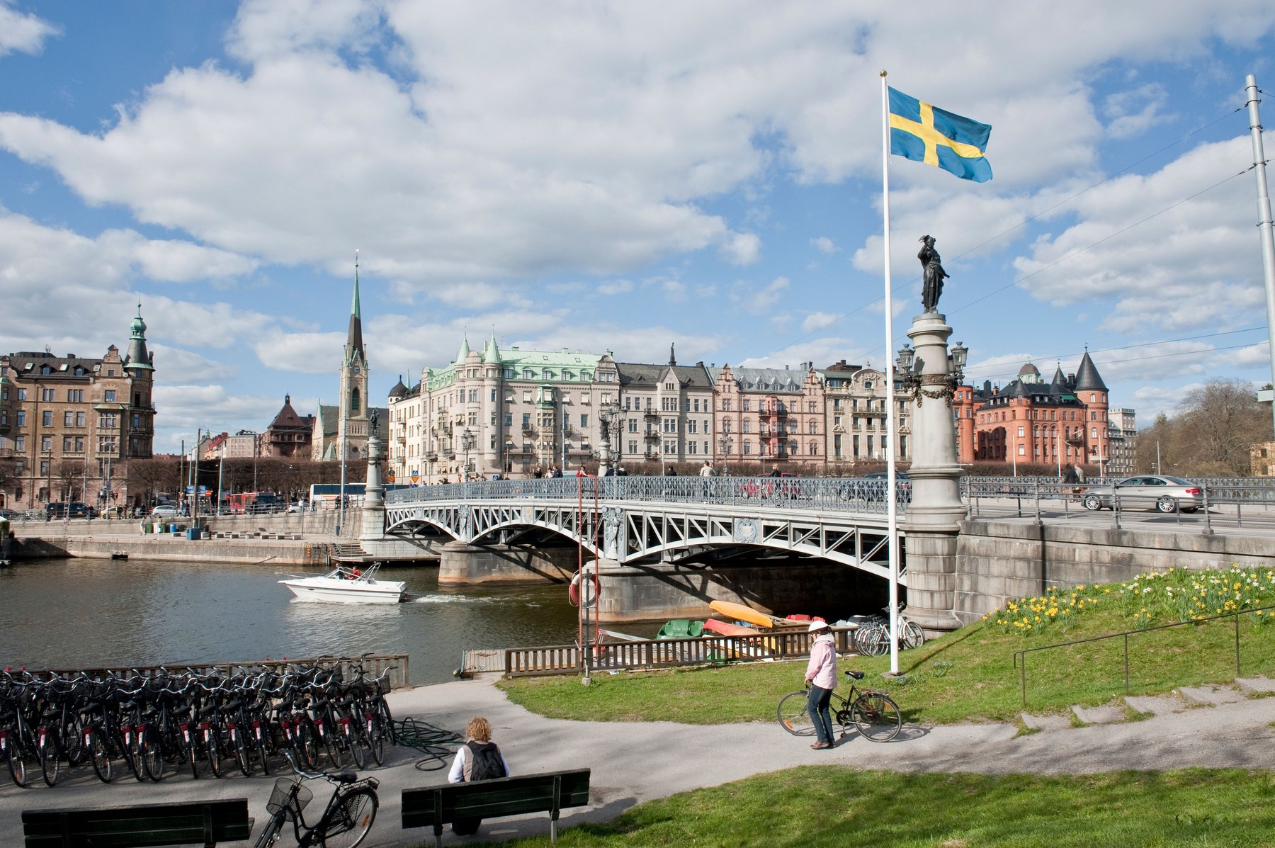 Swedish flag flying next to in the Djurgardsbron bridge in central Stockholm, Sweden.