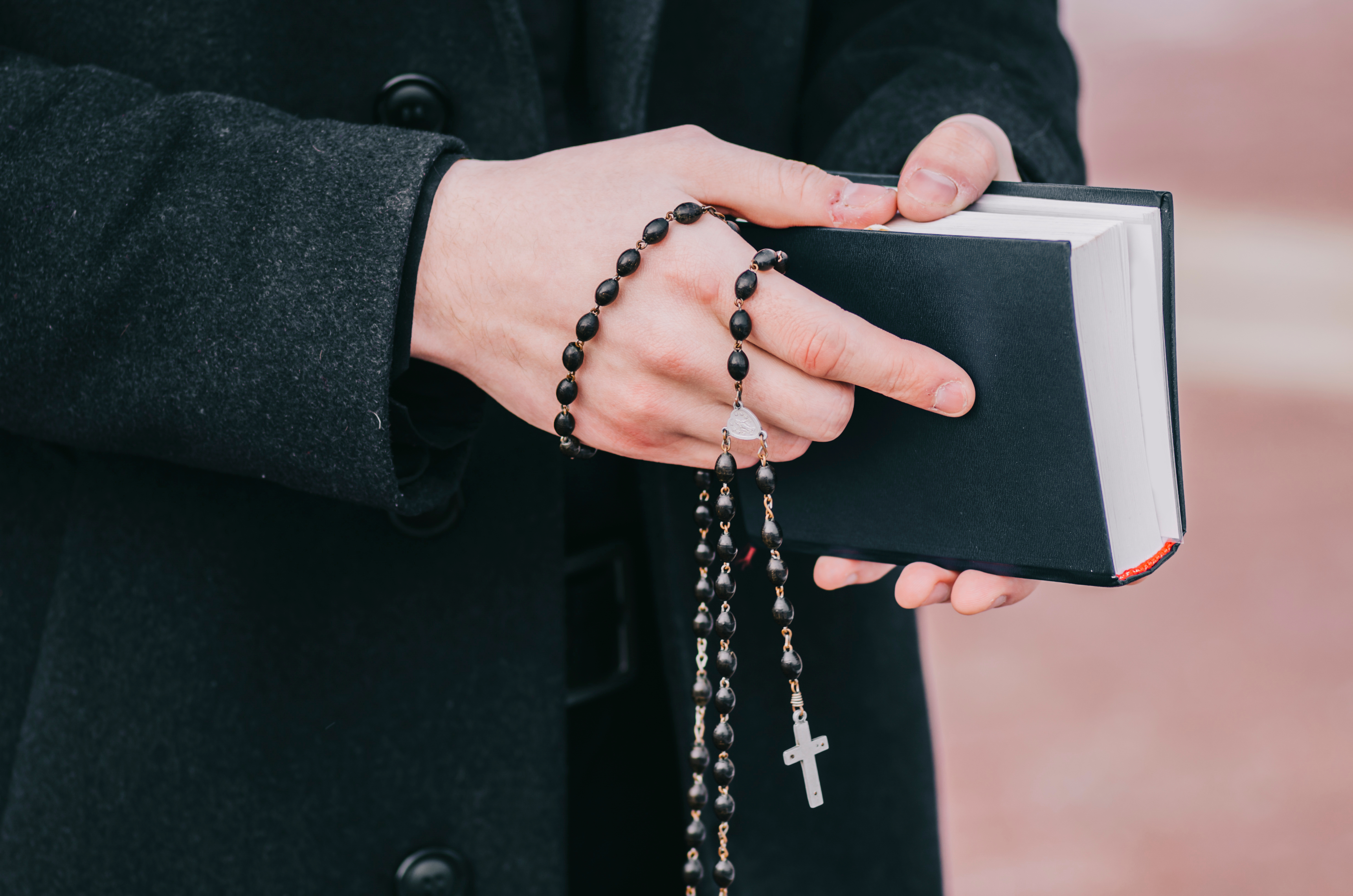Man,Priest,With,Book,On,Church,Street
