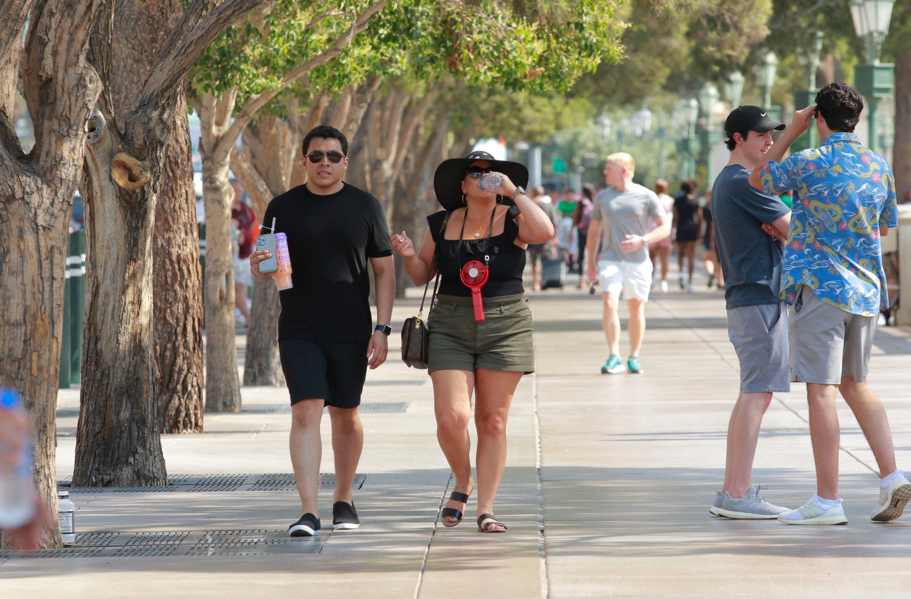 People walk along the Las Vegas Strip during an excessive heat warning, June 16, 2021, in Las Vegas, Nevada.,Image: 616091531, License: Rights-managed, Restrictions: , Model Release: no, Credit line: Ronda Churchill / AFP / Profimedia