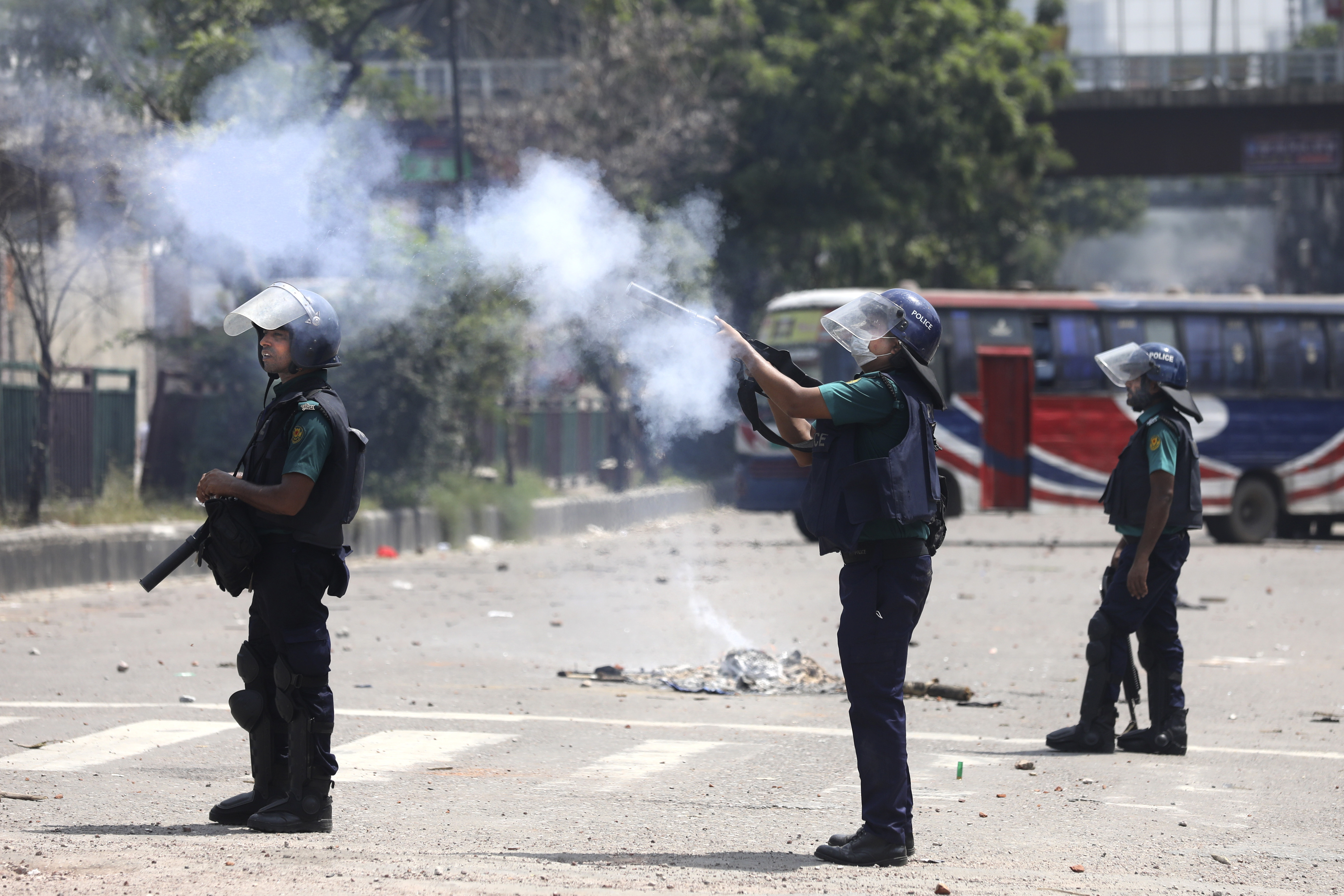 Policemen fire tear gas to disperse students protesting against the quota system in public service in Dhaka, Bangladesh, Thursday, July 18, 2024. (AP Photo/Rajib Dhar)