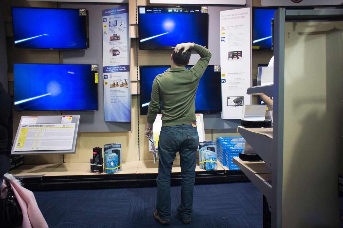 Shoppers browse flat-screen televisions in a Best Buy