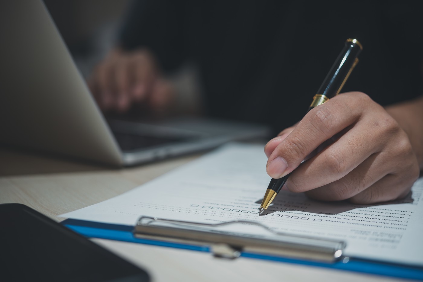 male individual is presently composing a job application within his workplace. business document,  signing contract.,Image: 830161680, License: Royalty-free, Restrictions: , Model Release: no, Credit line: Khunkorn Laowisit / Panthermedia / Profimedia