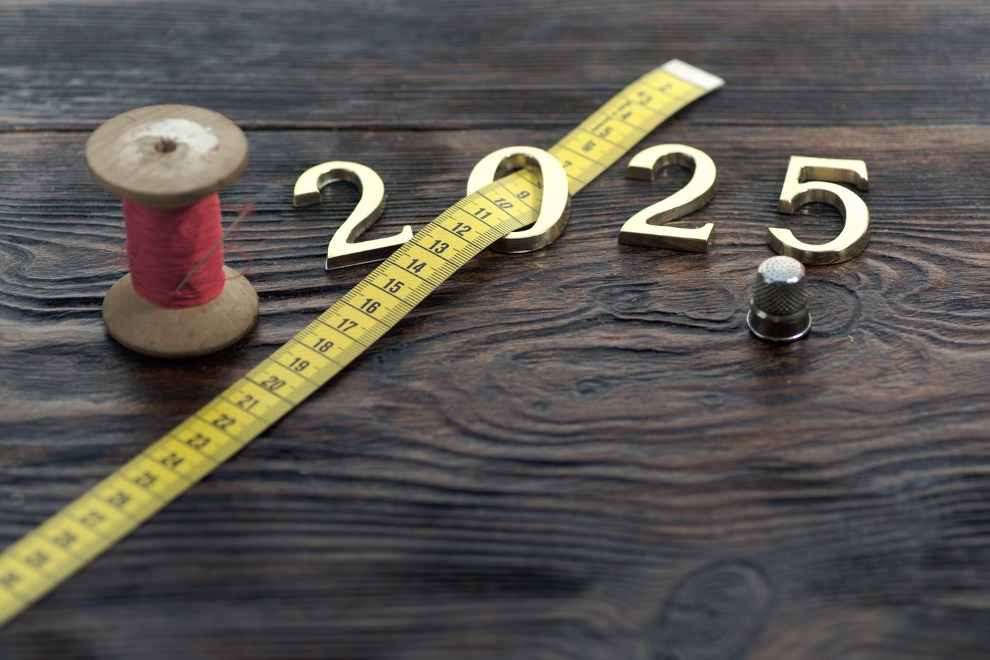 Happy New Year. Symbol from number 2025 on wooden background