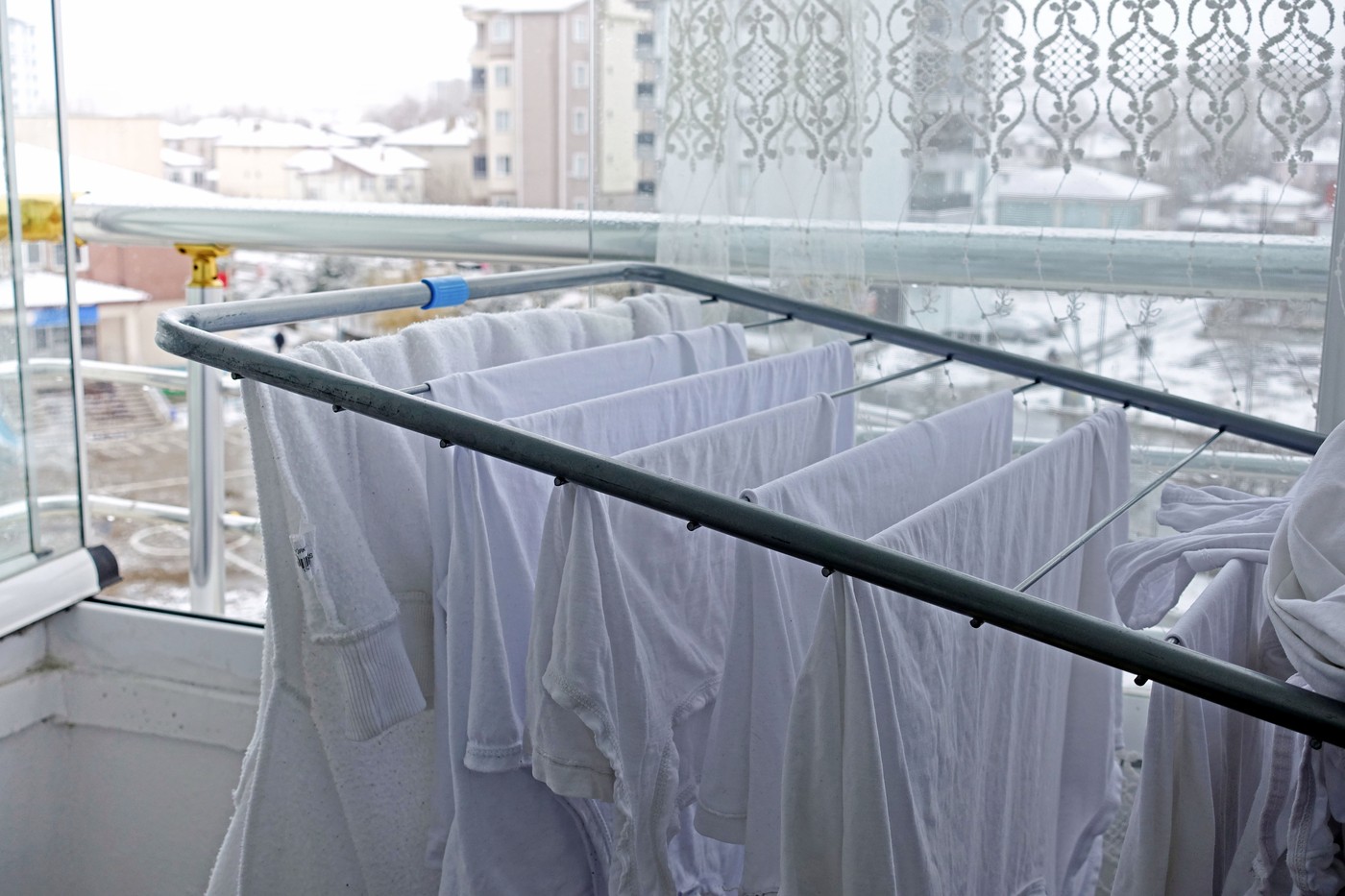 drying clothes on the balcony in winter, white clothes drying on the clothes hanger, drying the balcony and laundry,