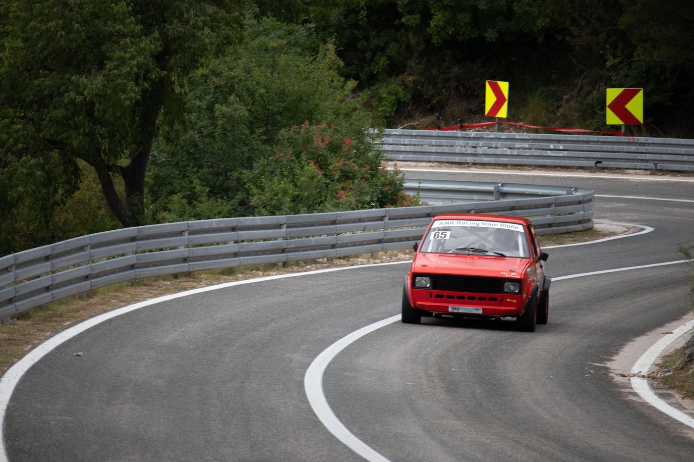 Skradin Croatia, June 2020 Simple red old Yugoslavian "Yugo" modified for hill climb racing up hill, going through a bend at high speed