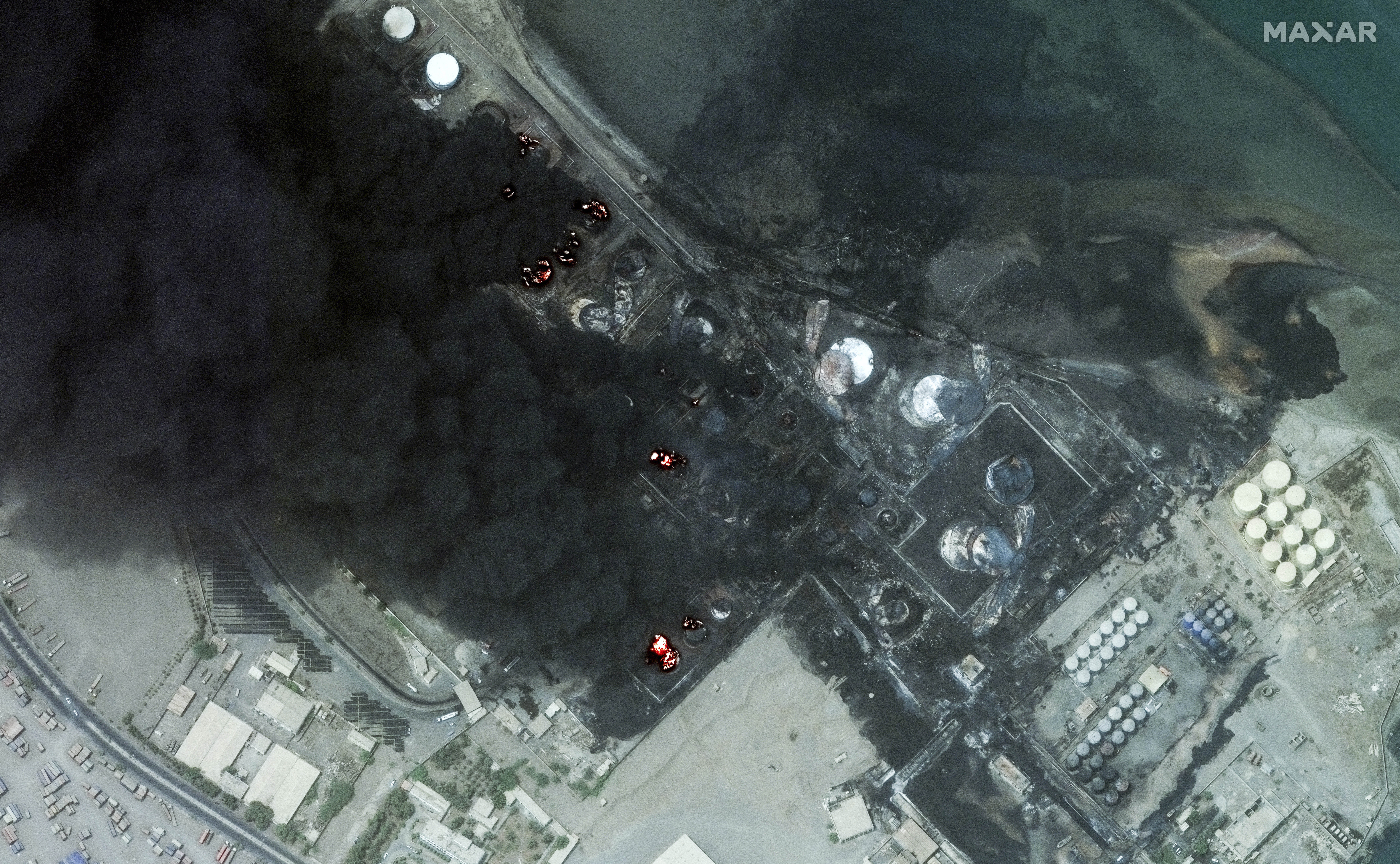 This satellite image provided by Maxar Technologies shows a close view of burning oil tanks in Hodeidah, Yemen, July 21, 2024. (Satellite image ©2024 Maxar Technologies via AP)