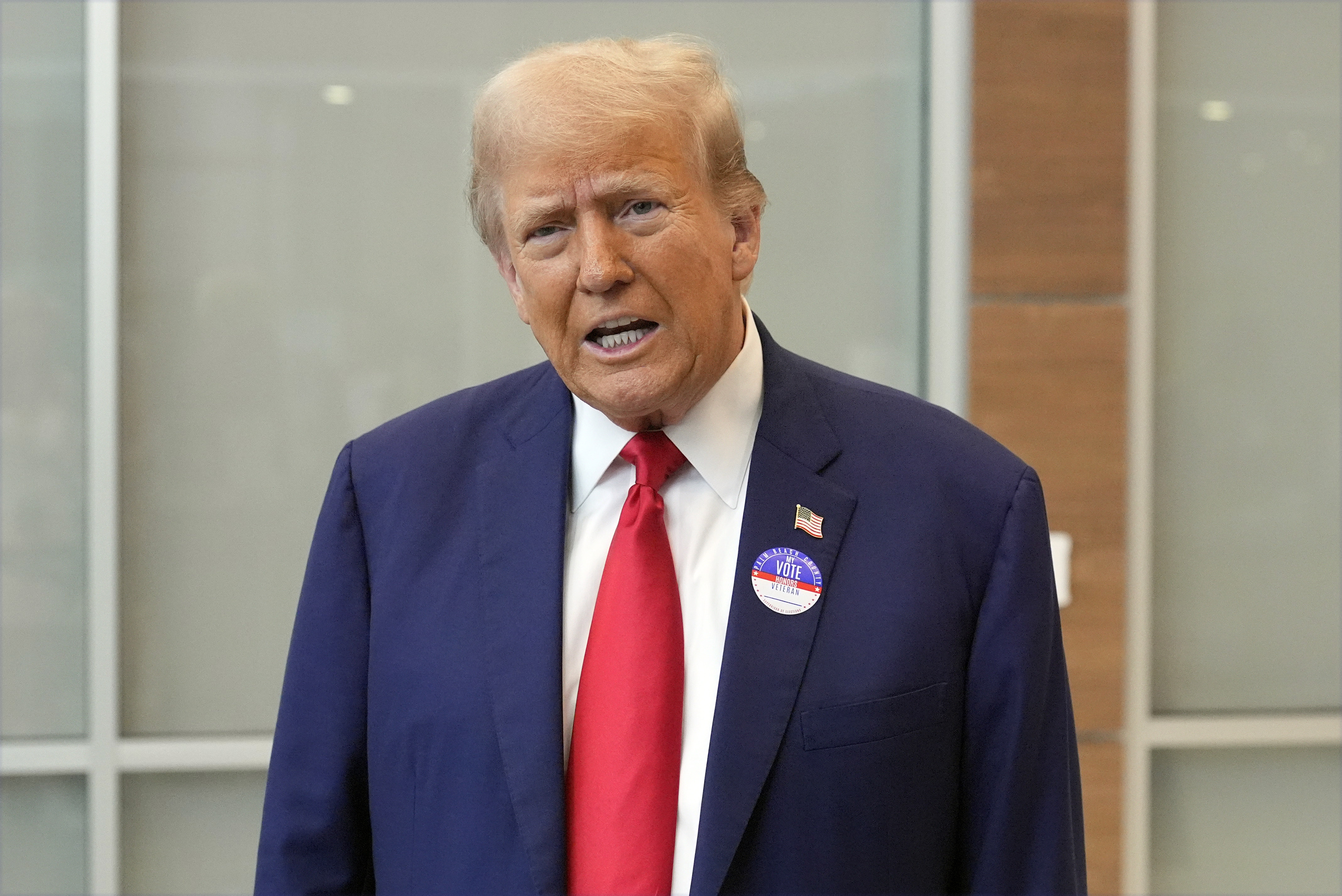 Republican presidential nominee former President Donald Trump talks at the Palm Beach County Supervisor of Elections, Wednesday, Aug. 14, 2024, in West Palm Beach, Fla., as he votes early in person in the Florida primary. (AP Photo/Wilfredo Lee)
