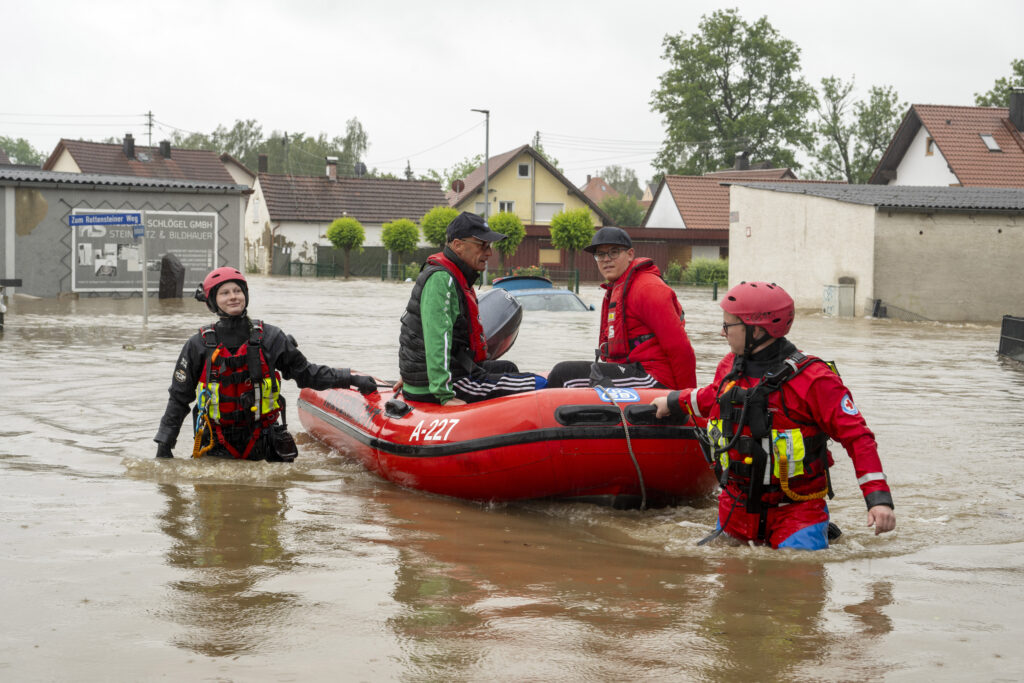 Residents are rescued with a dinghy from a flooded house, in Babenhausen, Germany, Saturday, June 1, 2024 following a several days of heavy rainfall. (Stefan Puchner/dpa via AP)