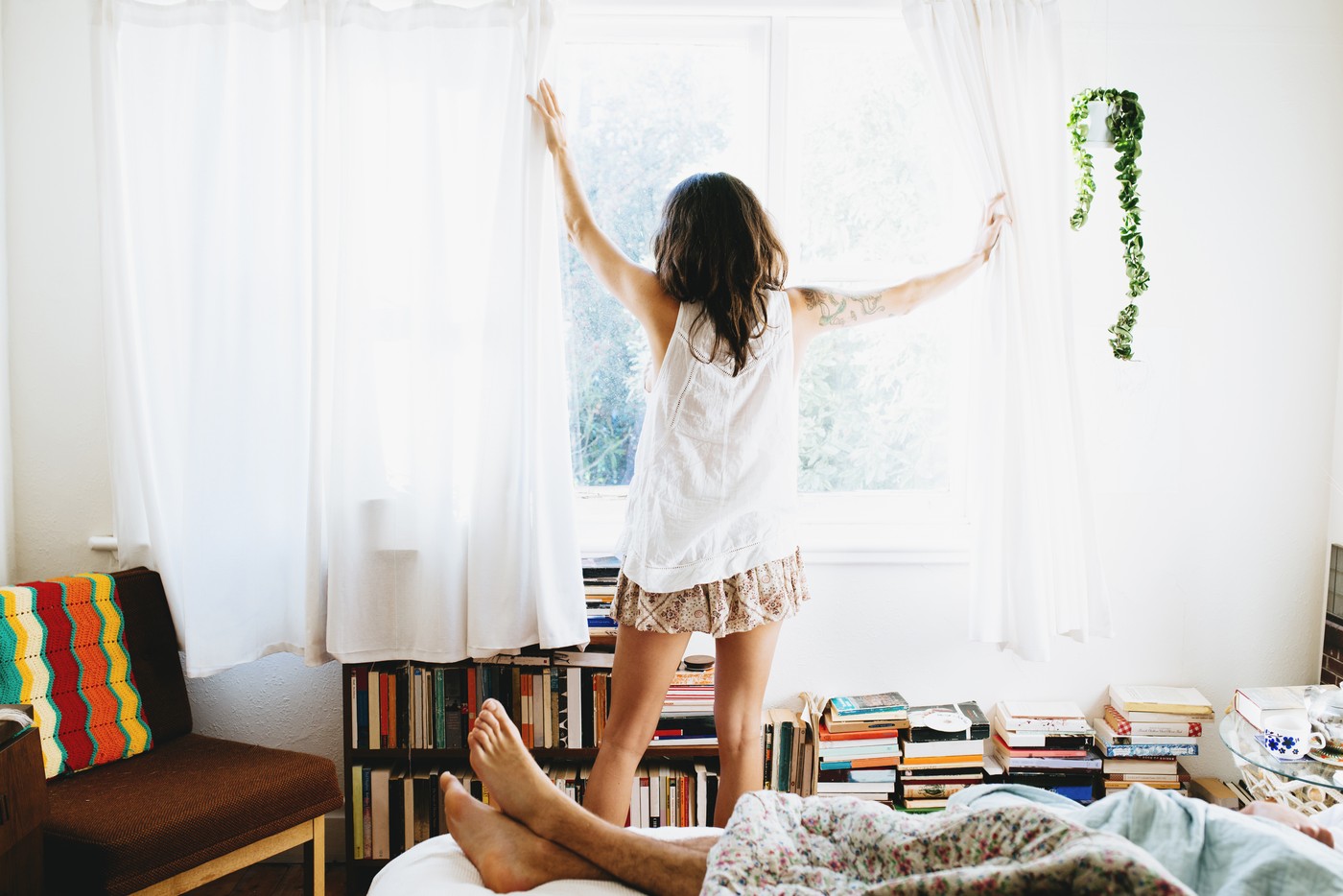 Woman drawing curtains open