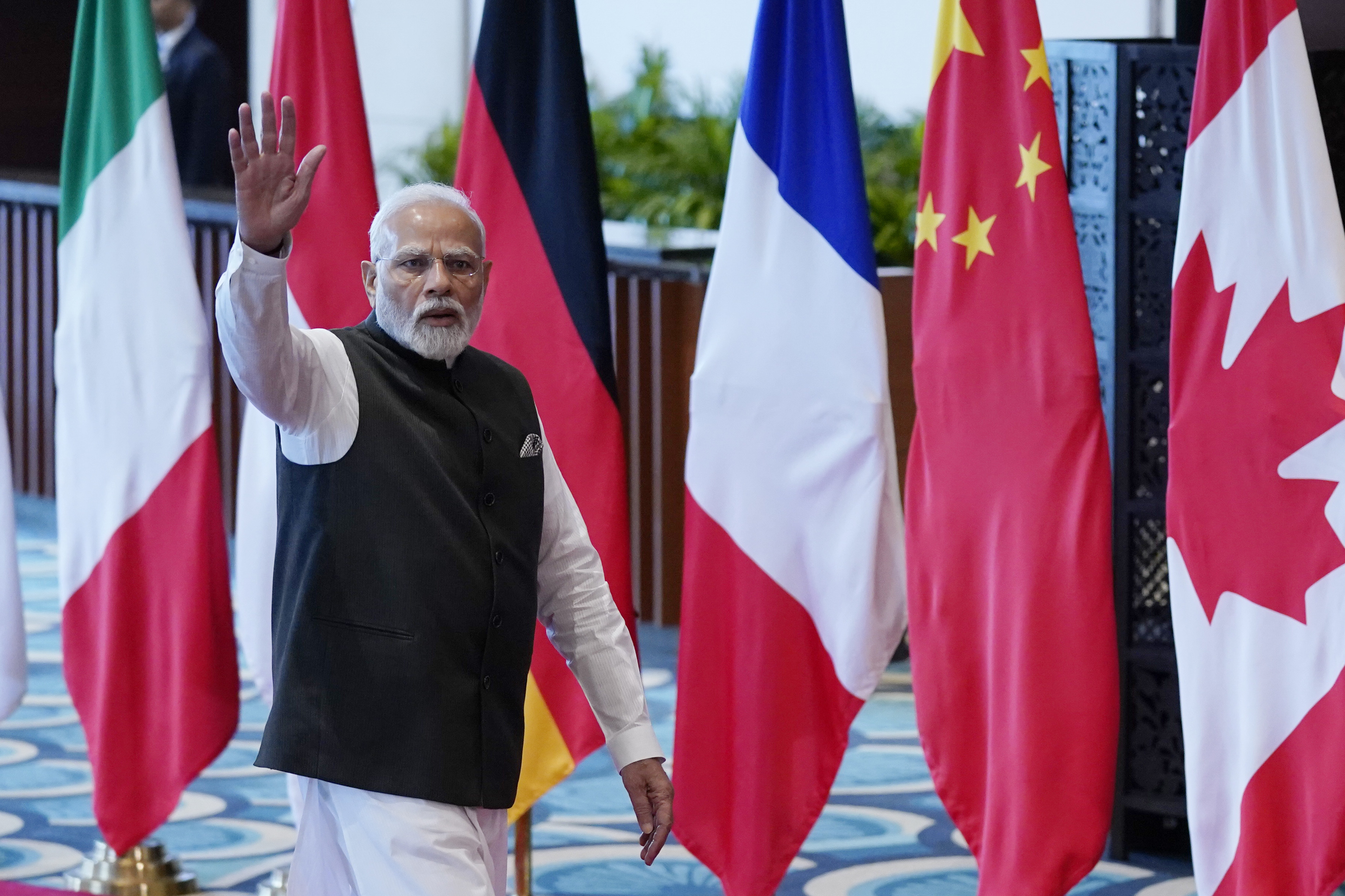 Indian Prime Minister Narendra Modi waves as he arrives at Bharat Mandapam convention center for the G20 Summit, in New Delhi, India, Saturday, Sept. 9, 2023. (AP Photo/Evan Vucci,Pool)