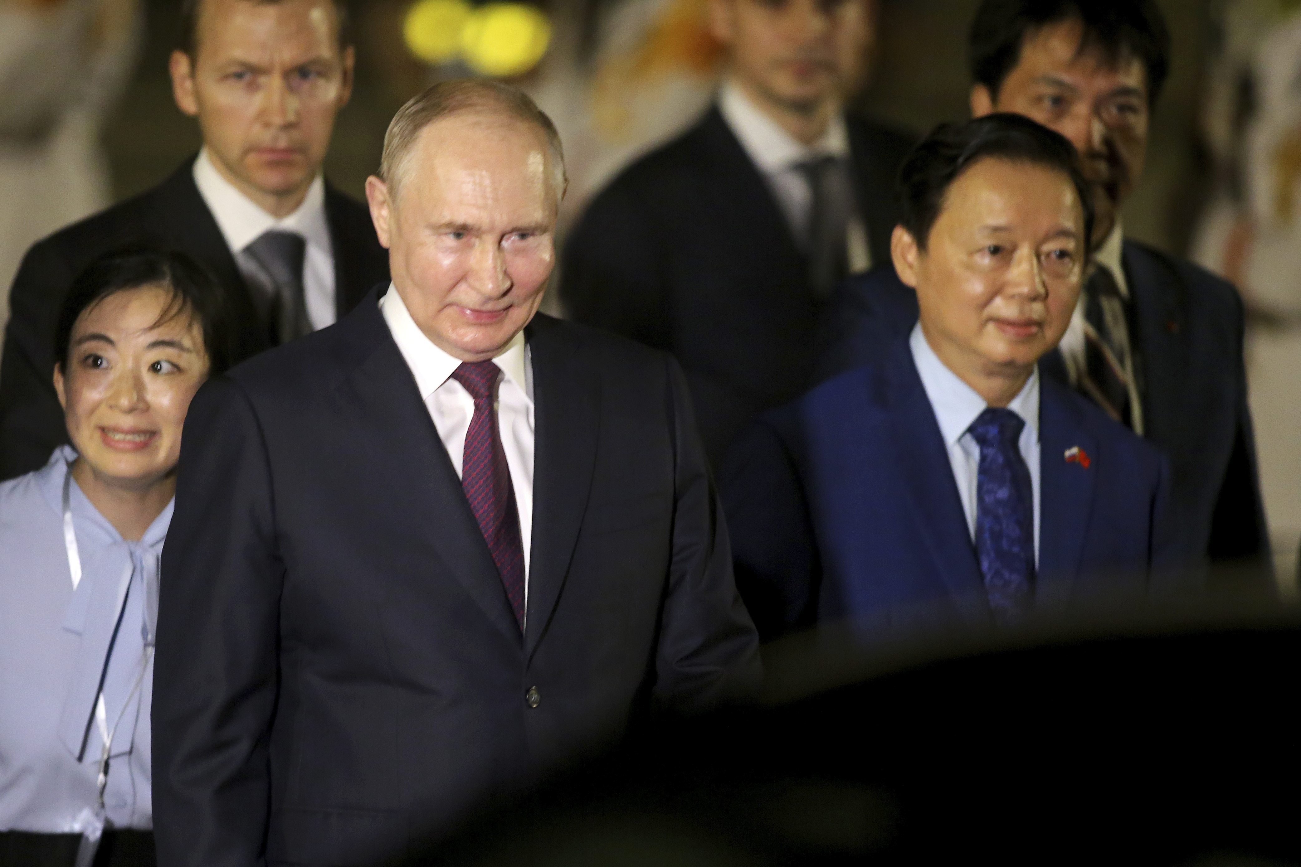 Russian President Vladimir Putin, left, and Vietnamese Deputy Prime Minister Tran Hong Ha walk together after Putin's arrival at the Noi Bai International Airport in Hanoi, Vietnam, Thursday, June. 20, 2024. (AP Photo/Minh Hoang)