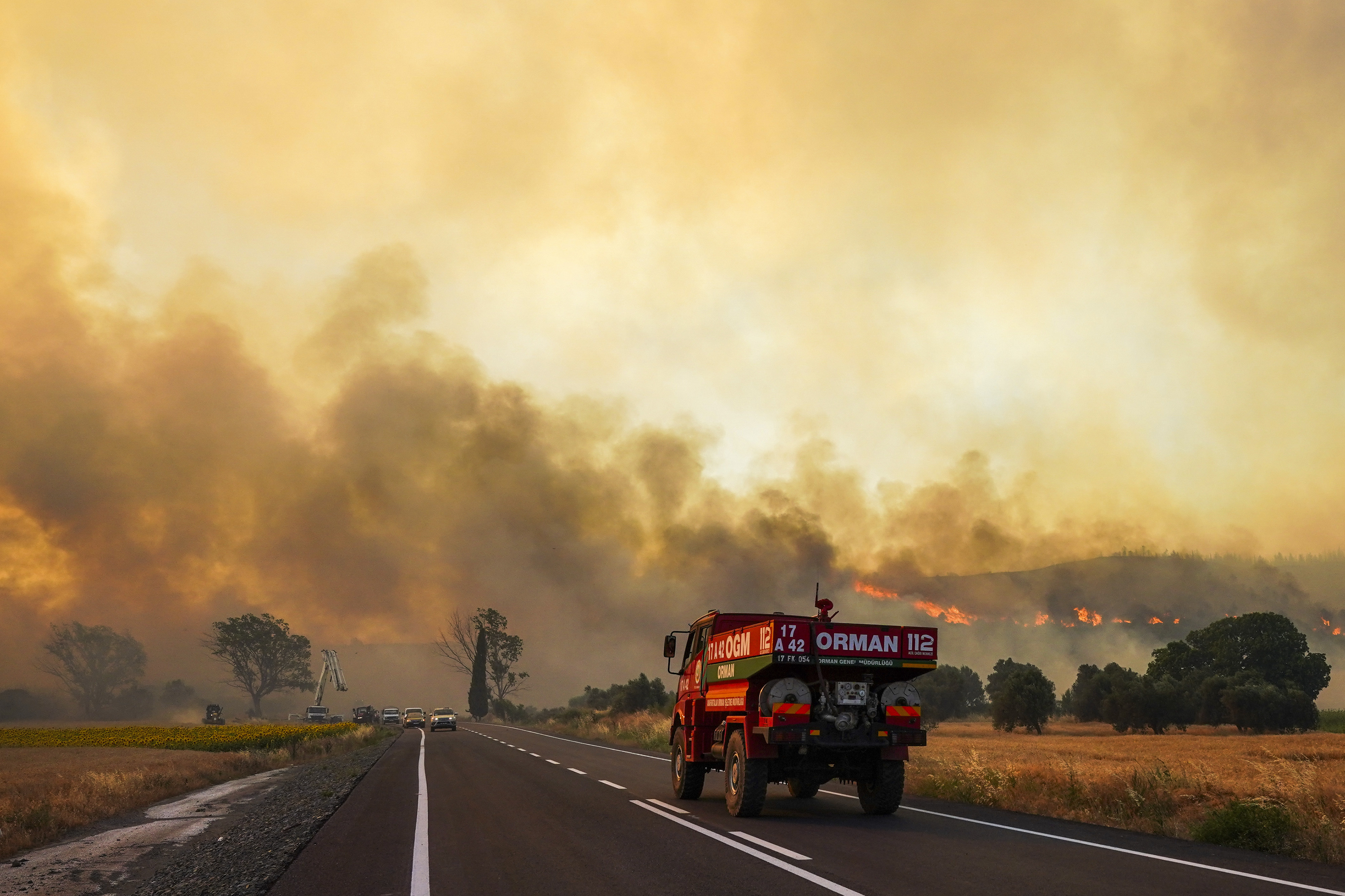 Firefighters work to extinguish a fire burning near Kumkoy, in Gallipoli peninsula, Turkey, Tuesday, June 18, 2024. (Sercan Ozkurnazli/Dia Photo via AP)