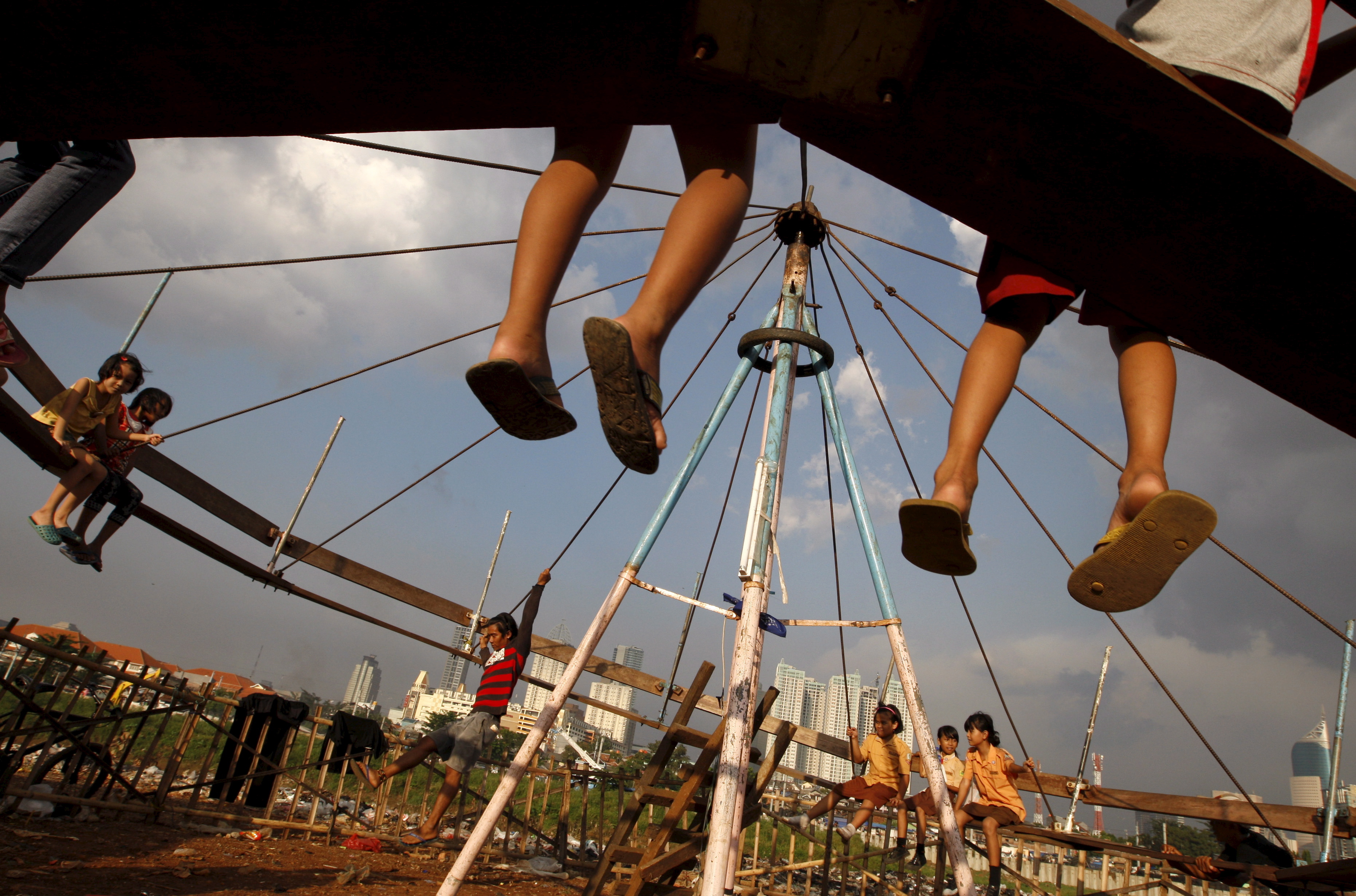 Ringišpil, Children play on a human-powered carousel at a slumm area in Jakarta