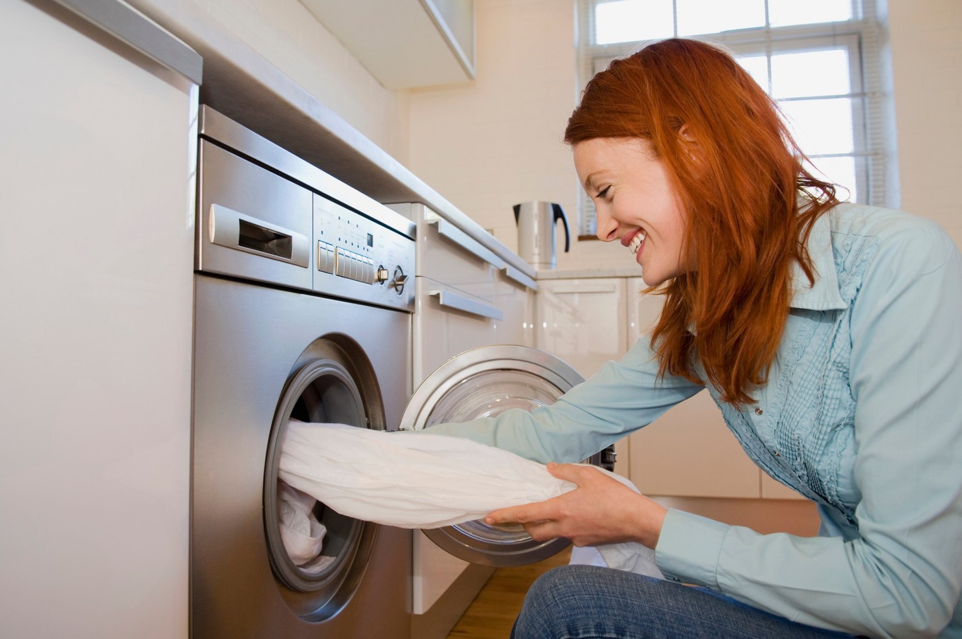 Woman unloading washing machine