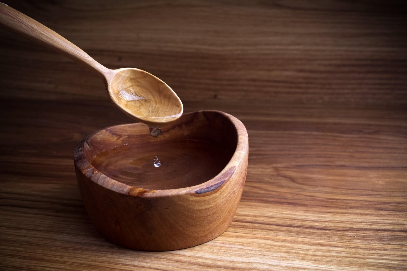 Fasting, Lent. Spoon and cup of water on wooden background