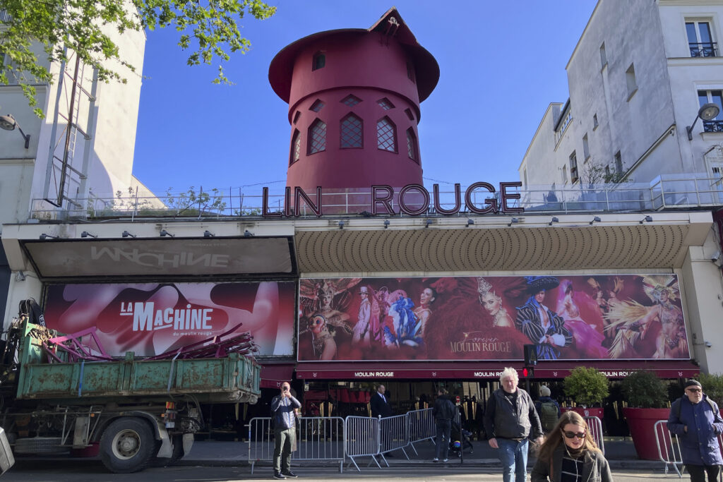 The Moulin Rouge (Red Mill) cabaret is seen Thursday April 25, 2024 in Paris. The windmill from the Moulin Rouge, the 19th century Parisian cabaret, has fallen off the roof overnight along with some of the letters in its name. (AP Photo/Oleg Cetinic)
