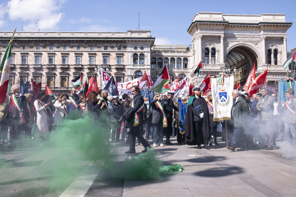 Demonstrators hold Palestinian flags during a protest on the occasion of Liberation Day in Milan, Italy, Thursday April 25, 2024. (Alessandro Cimma/Lapresse via AP)