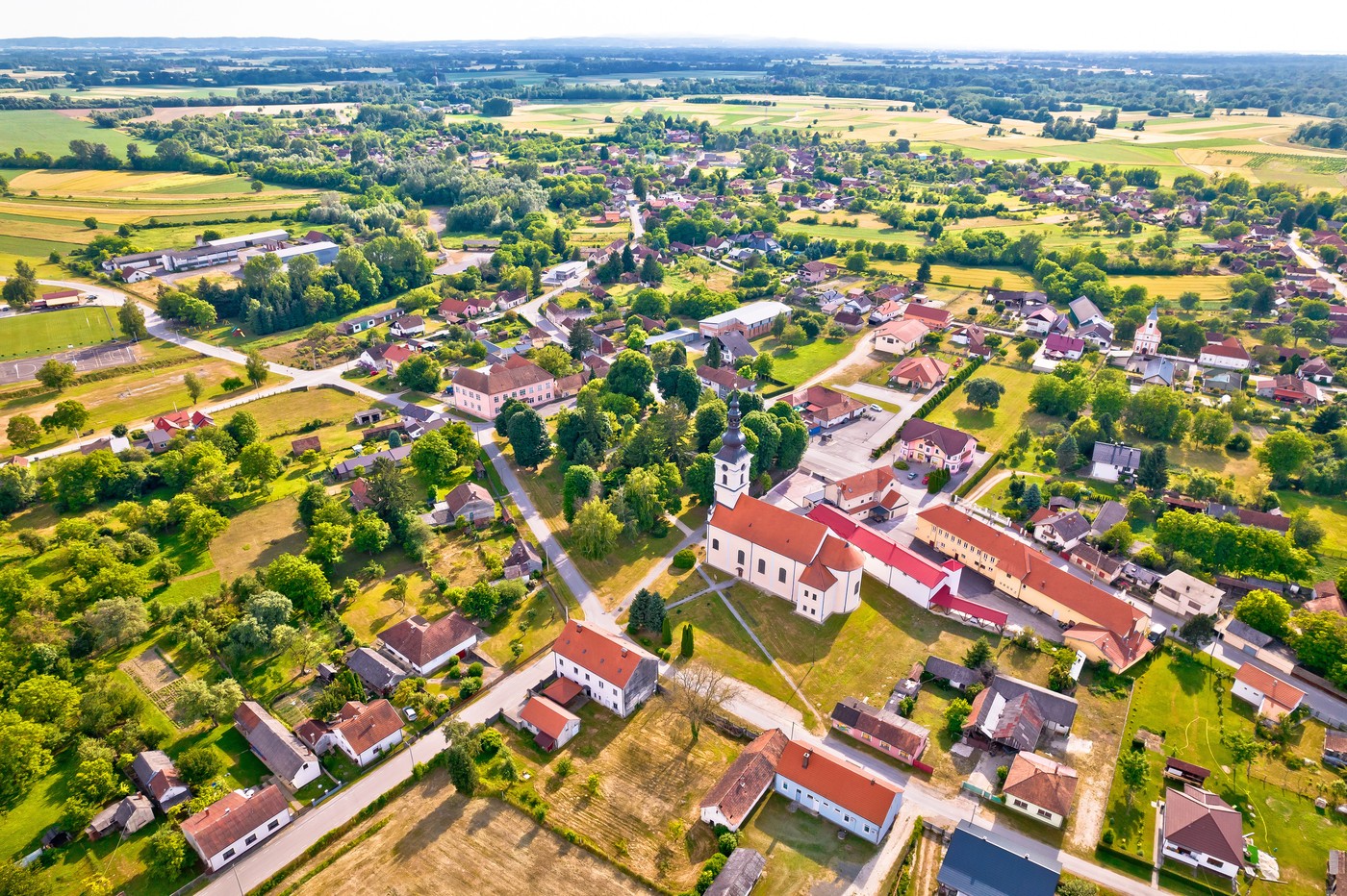 Village of Legrad church and green landscape aerial view