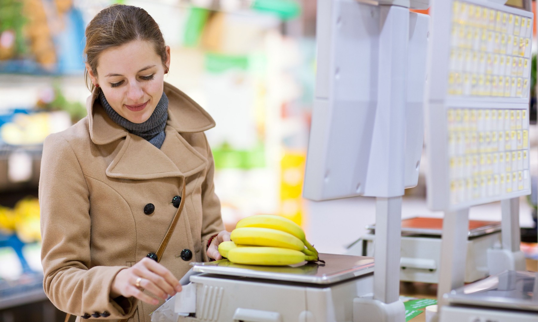 pretty woman buying fruit and vegetables in a supermarket/