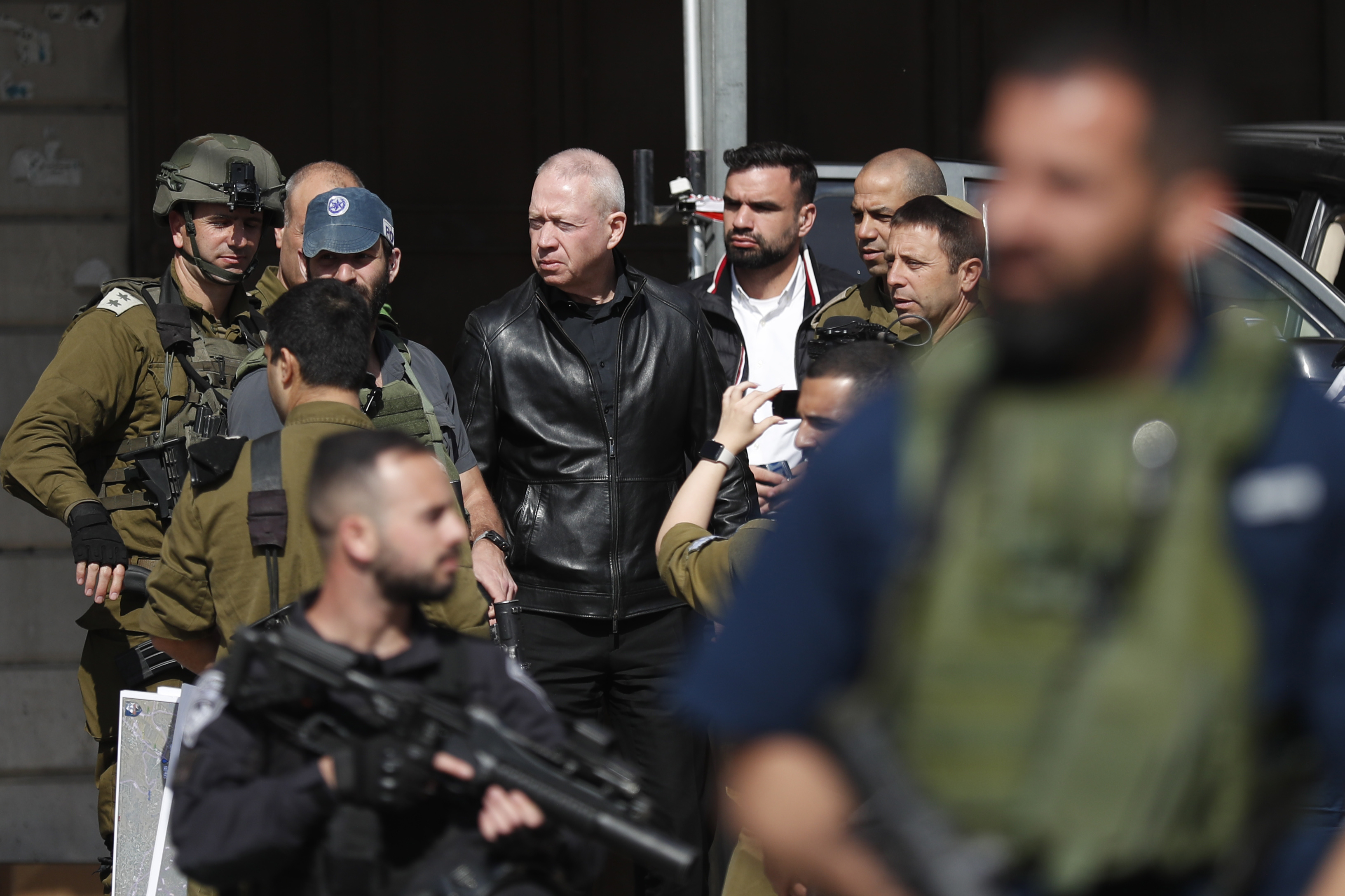 Israeli Defence Minister Yoav Galant visits the scene of a shooting attack in the West Bank town of Hawera