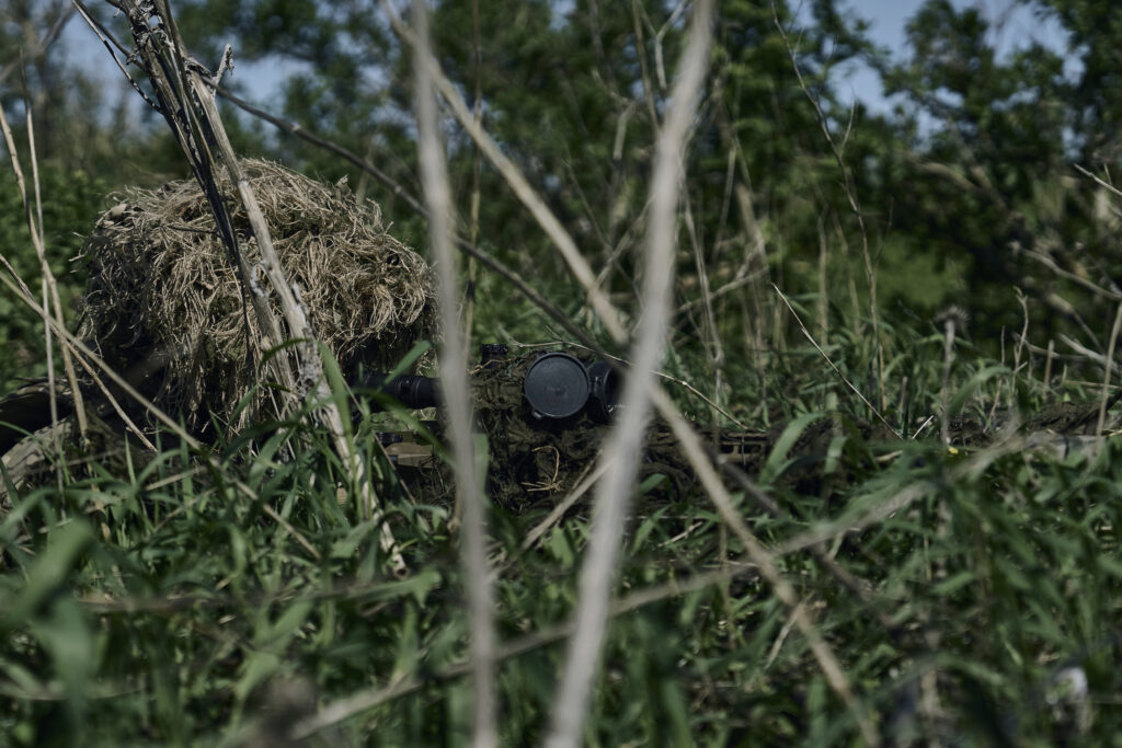 A Ukrainian army sniper at his position facing Russian troops near Bakhmut, Donetsk region, Ukraine, Tuesday, May 2, 2023. (AP Photo/Libkos)