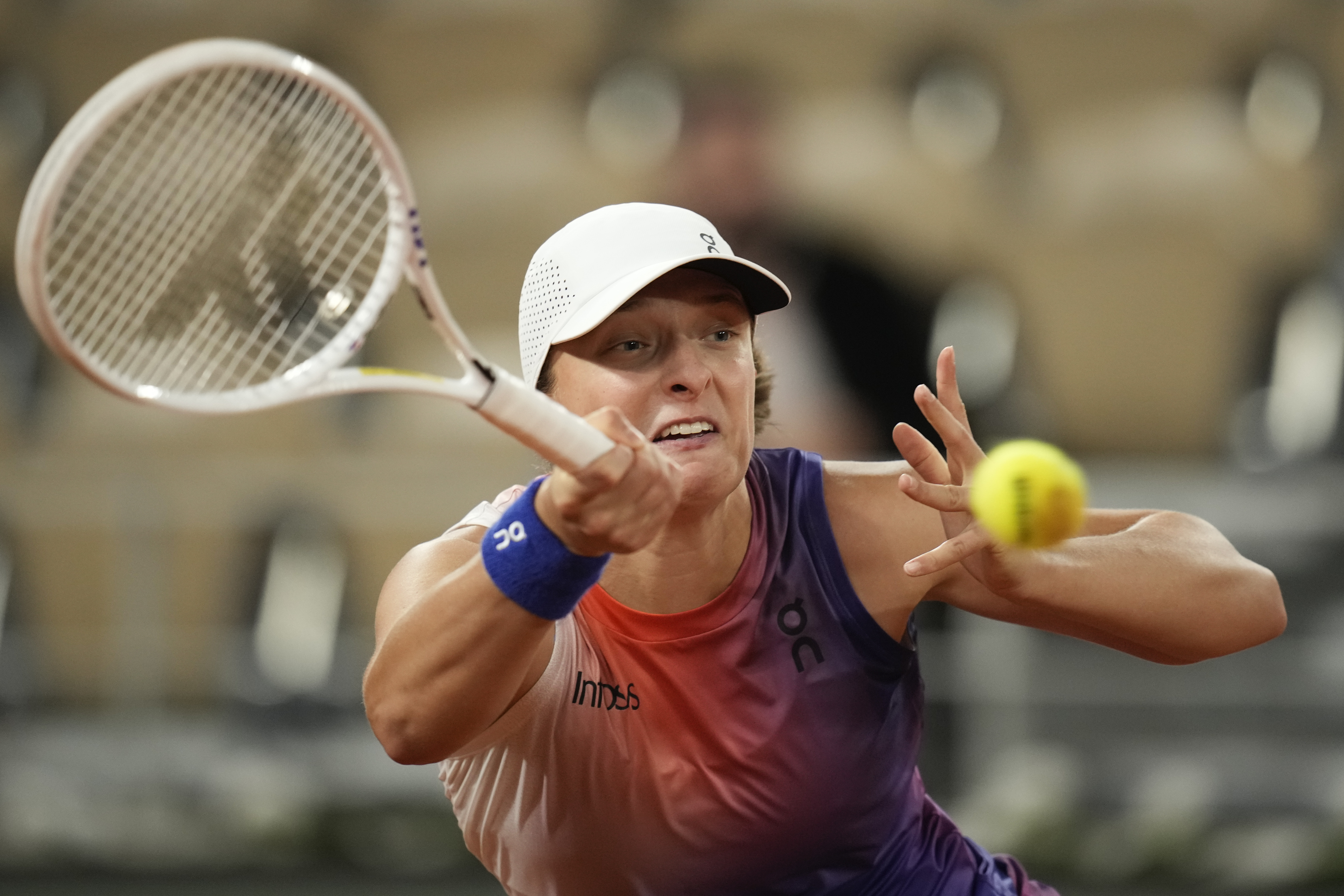 Poland's Iga Swiatek plays a shot against Marie Bouzkova of the Czech Republic during their third round match of the French Open tennis tournament at the Roland Garros stadium in Paris, Friday, May 31, 2024. (AP Photo/Christophe Ena)