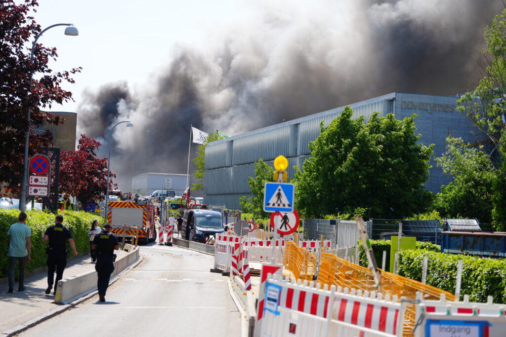 Police and firefighters secure the area around a fire at the Novo Nordisk headquarters in Bagsvaerd, near Copenhagen, Denmark, Wednesday, May 22, 2024. (Liselotte Sabroe/Ritzau Scanpix via AP)