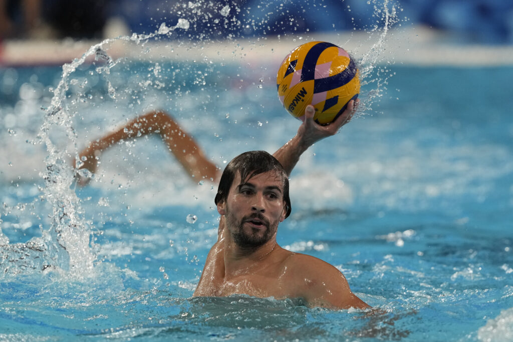 Serbia's Victor Rasovic looks for a teammate to pass to during a men's water polo Group B preliminary match between Serbia and France, at the 2024 Summer Olympics, Saturday, Aug. 3, 2024, in Saint-Denis, France. (AP Photo/Luca Bruno)