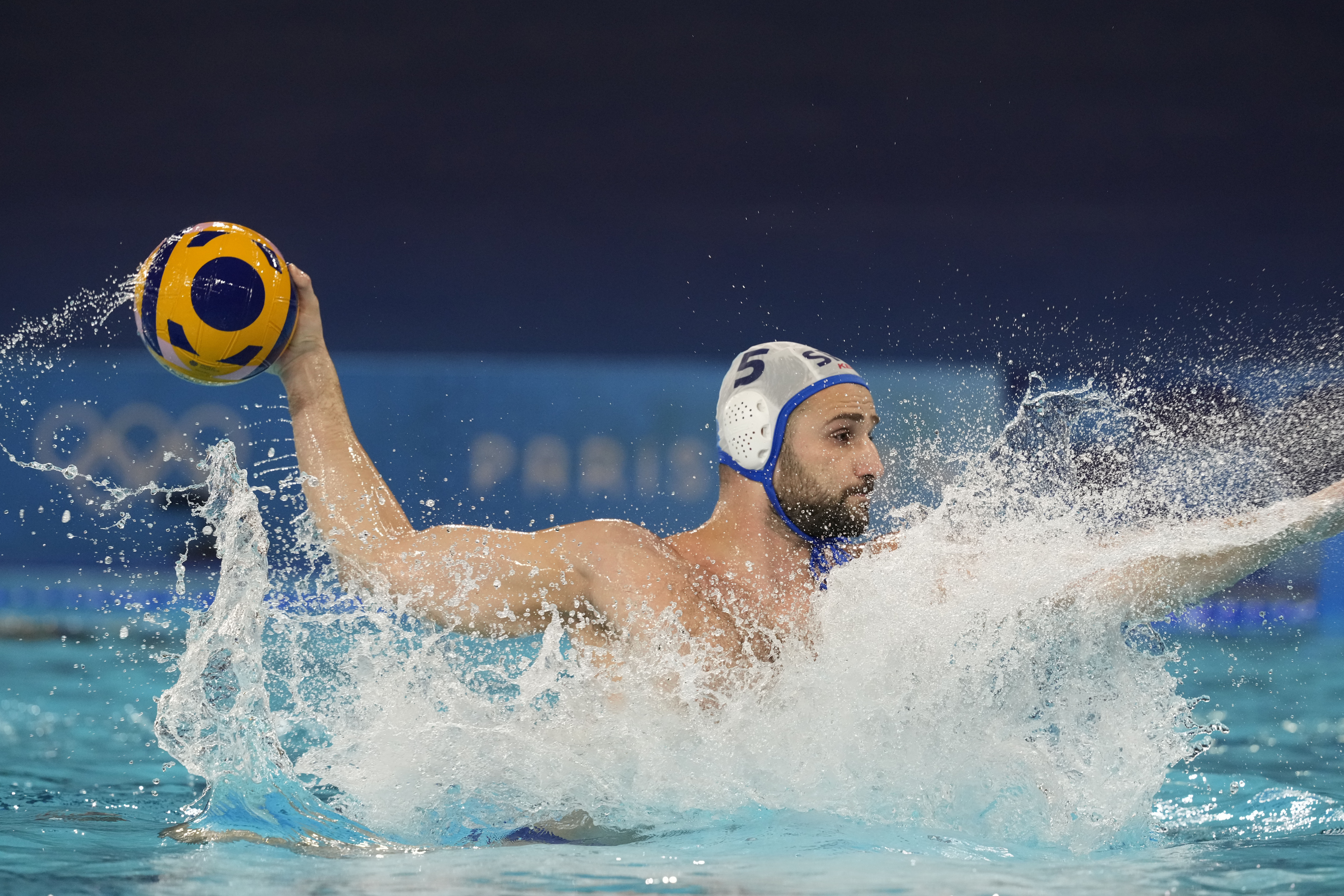 Serbia's Milos Cuk shoots to score during a men's water polo Group B preliminary match between Serbia and Spain, at the 2024 Summer Olympics, Thursday, Aug. 1, 2024, in Saint-Denis, France. (AP Photo/Luca Bruno)
