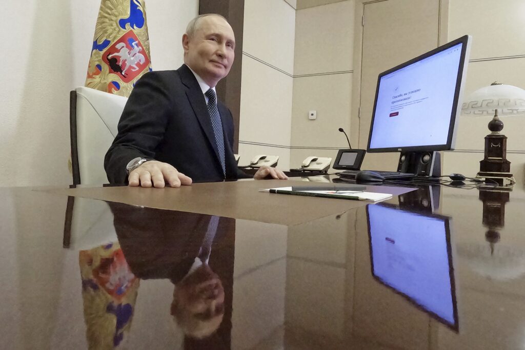 Russian President Vladimir Putin attends an electronic voting during a presidential voting at the Novo-Ogaryovo state residence outside Moscow, Russia, Friday, March 15, 2024. (Mikhail Metzel, Sputnik, Kremlin Pool Photo via AP)