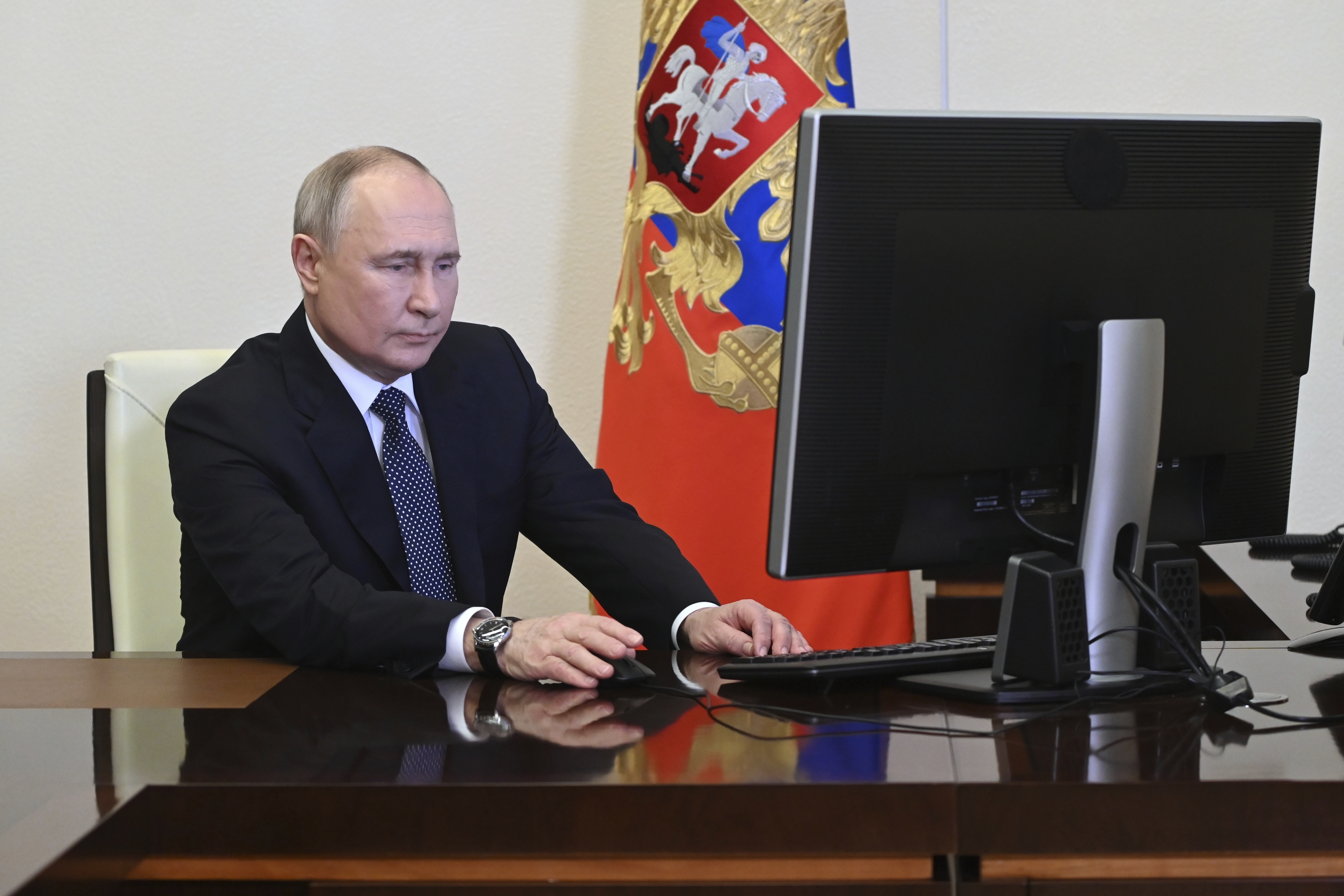 Russian President Vladimir Putin attends an electronic voting during a presidential voting at the Novo-Ogaryovo state residence outside Moscow, Russia, Friday, March 15, 2024. (Pavel Byrkin, Sputnik, Kremlin Pool Photo via AP)