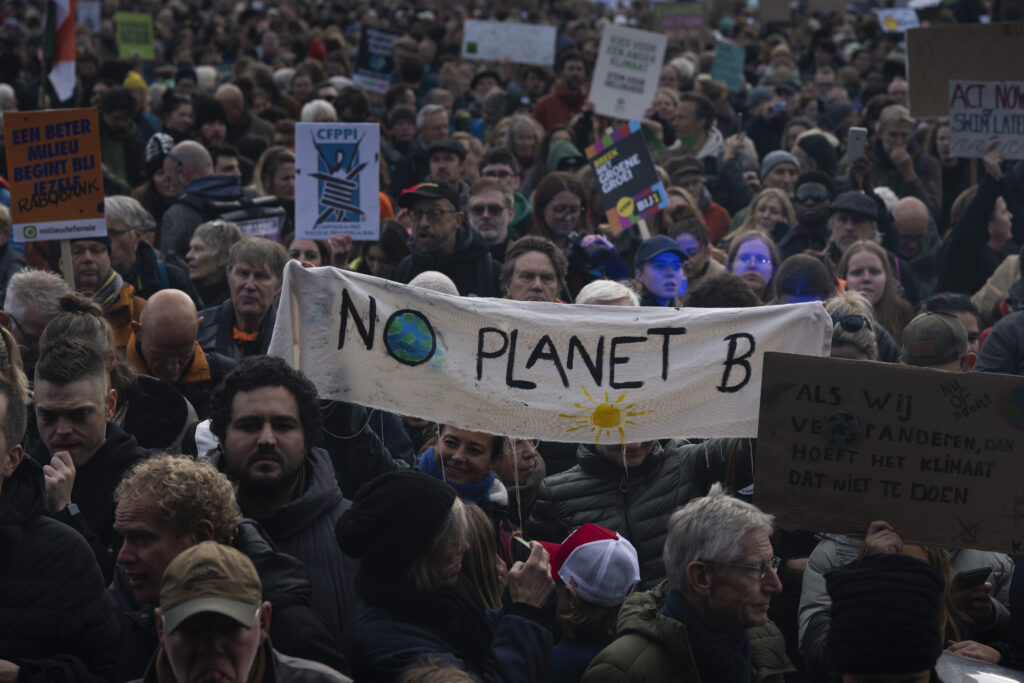 Tens of thousands of people marched through Amsterdam, Netherlands, Sunday, Nov. 12, 2023, to call for more action to tackle climate change. (AP Photo/Peter Dejong)