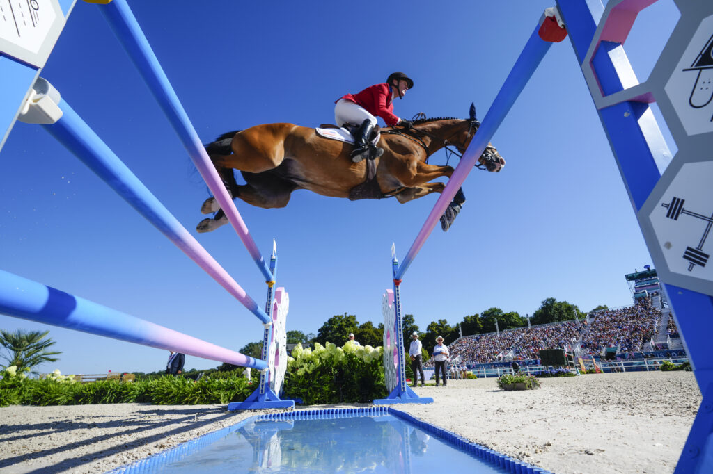 USA's McLain Ward, riding Ilex, during the Equestrian Jumping qualifiers, at the 2024 Summer Olympics, Monday, Aug. 5, 2024, in Versailles, France. (AP Photo/Mosa'ab Elshamy)