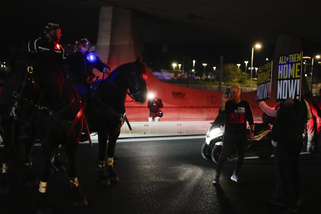 Police try to disperse demonstrators blocking a road during a protest calling for the release of Israeli hostages held in the Gaza Strip by the Hamas militant group, in Tel Aviv, Israel, Saturday, March 16, 2024. (AP Photo/Ohad Zwigenberg)