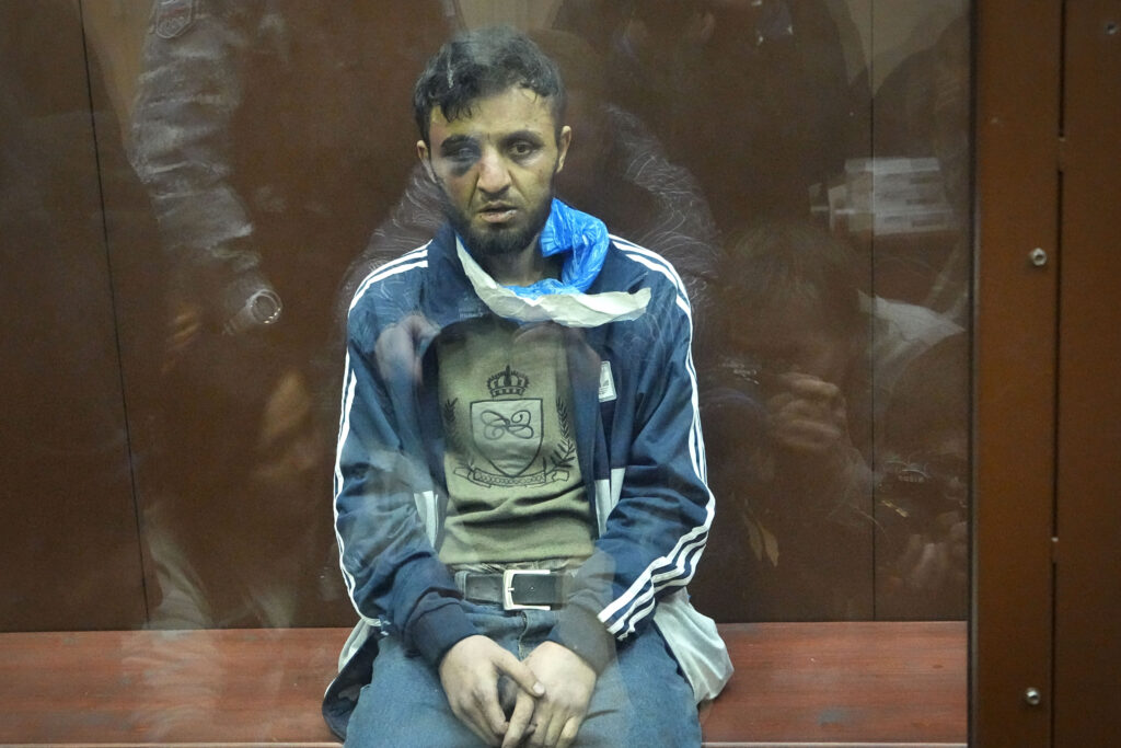 A suspect in the Crocus City Hall shooting on Friday sits in a courtroom in the Basmanny District Court, in Moscow, Russia, Sunday, March 24, 2024. (AP Photo/Alexander Zemlianichenko)