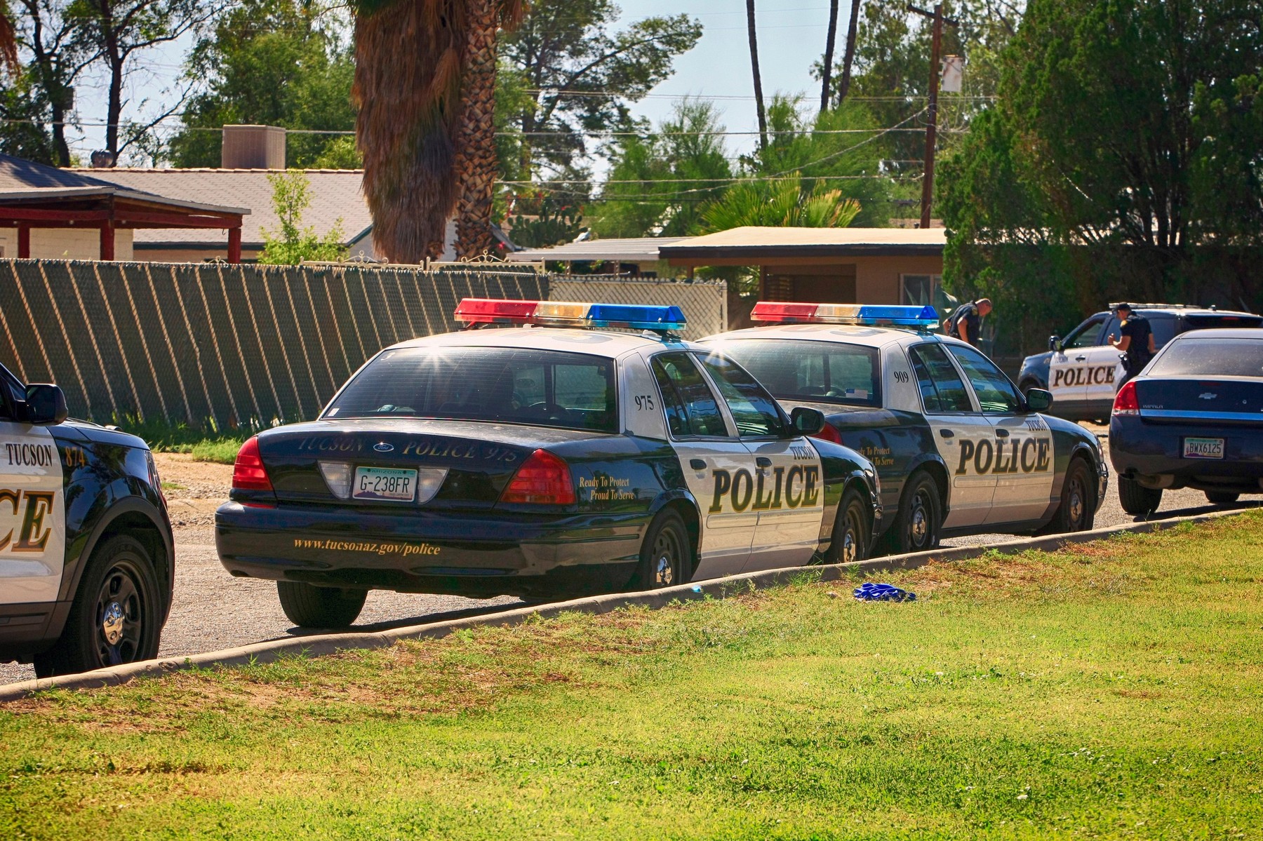Tucson Police Department vehicles parked at the scene of a shooting in the suburbs of this American city
